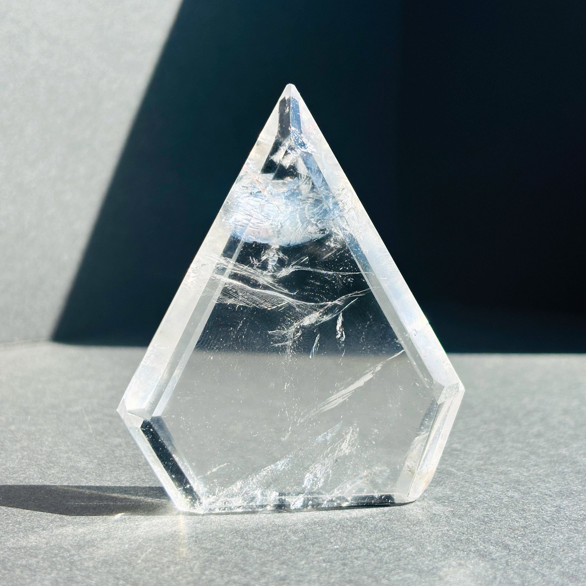 Clear Quartz Crystal Boho Chic Stone Sculpture against a black background