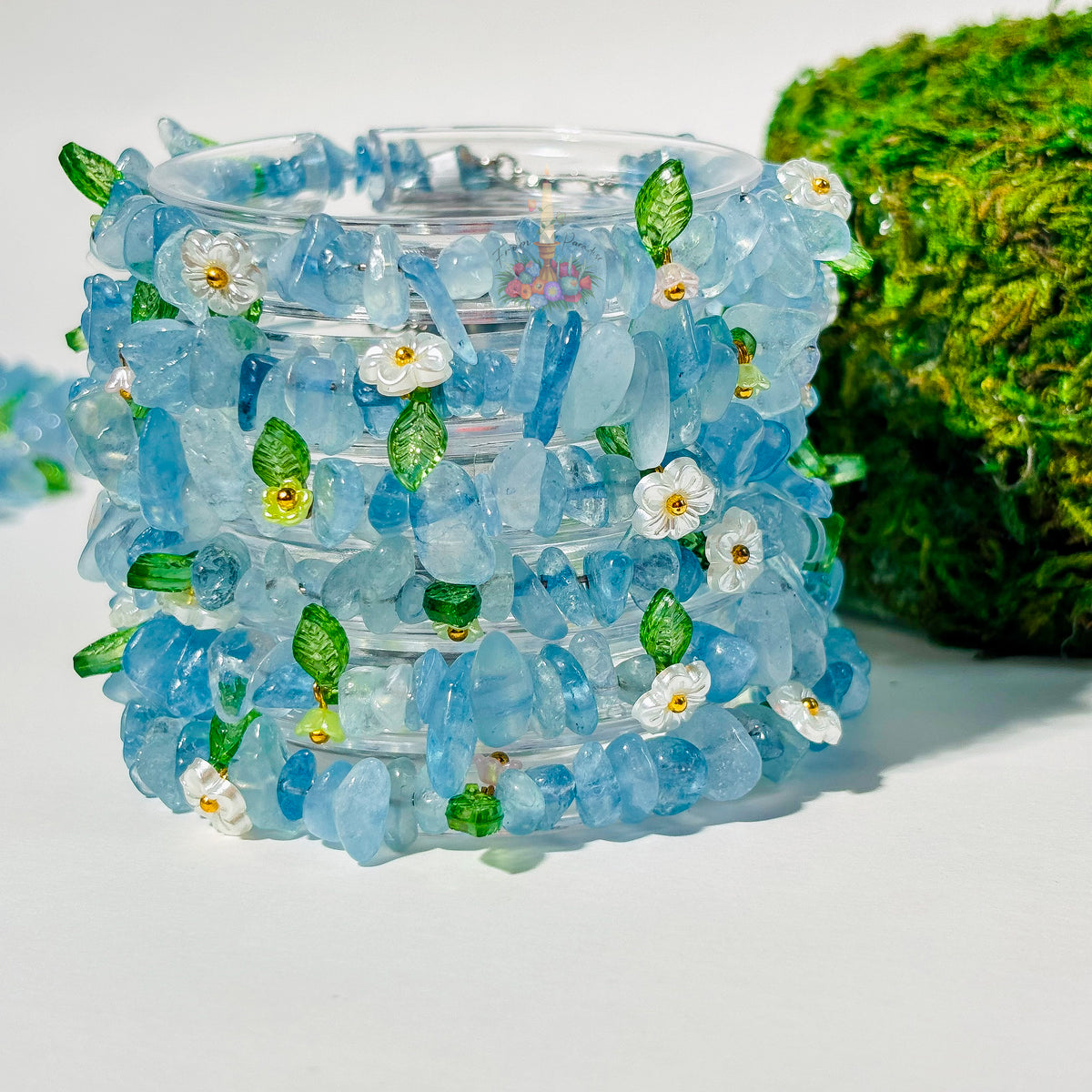 Stack of Aquamarine Flower Fairy Crystal Bracelets from From Paradise with floral accents.