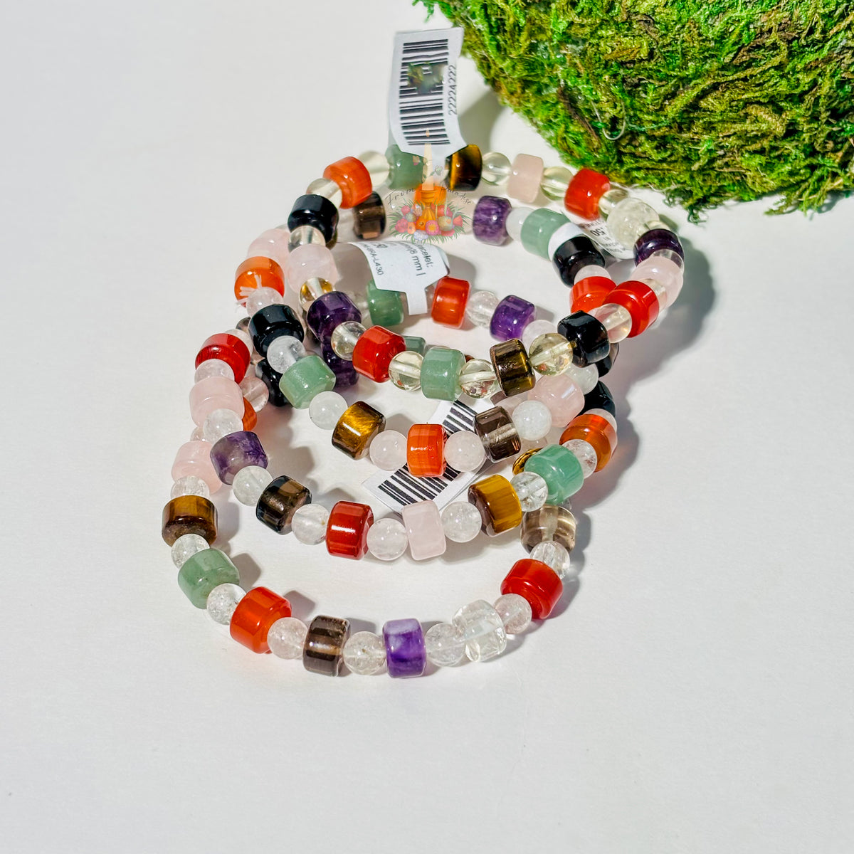 Stack of multi-gemstone crystal bracelets in various colors for balance and protection.