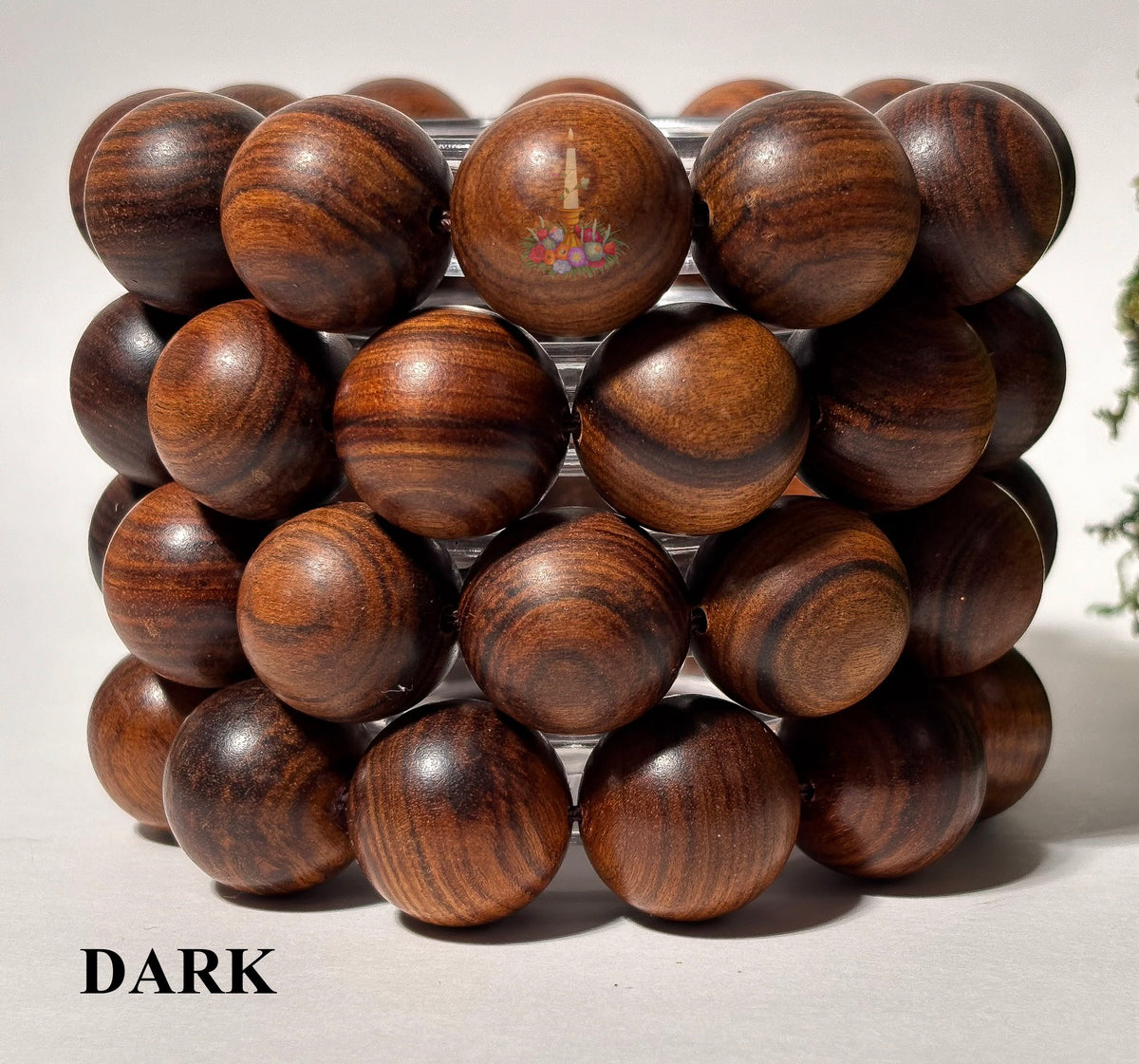 Wooden bead bracelet on a white background with 'DARK' label