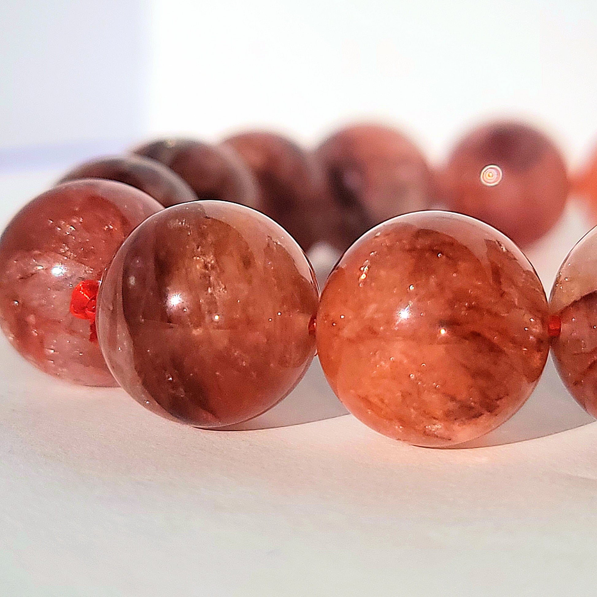 close up picture of fire quartz beads on bracelet