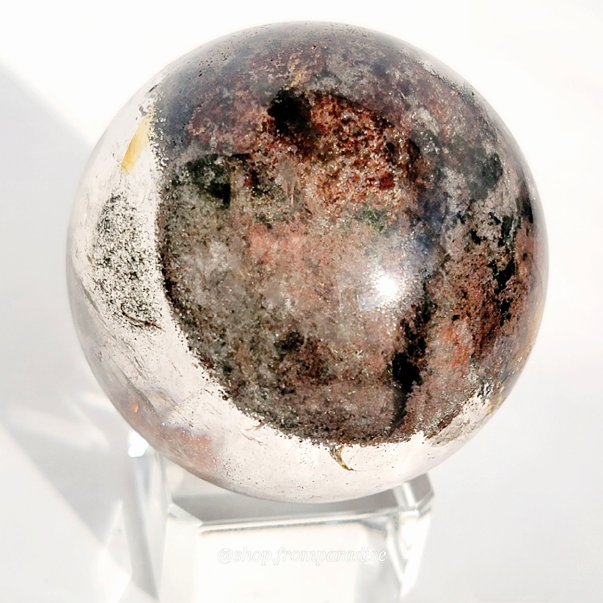 Garden Quartz Sphere on glass sphere stand against white background