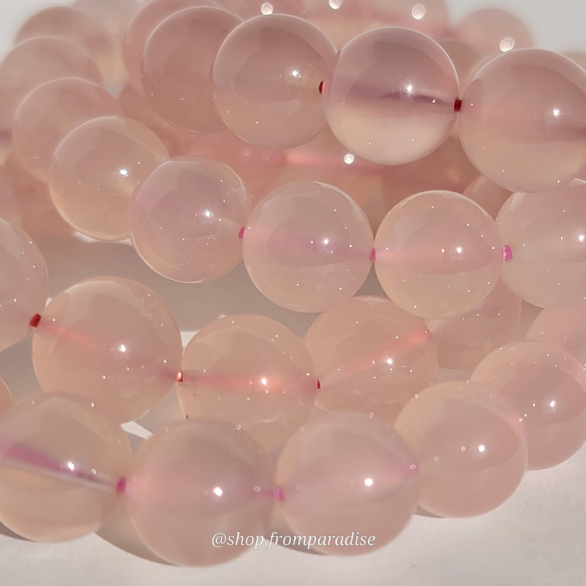 Rose Chalcedony Crystal Bracelet against white background in natural sunlight lighting