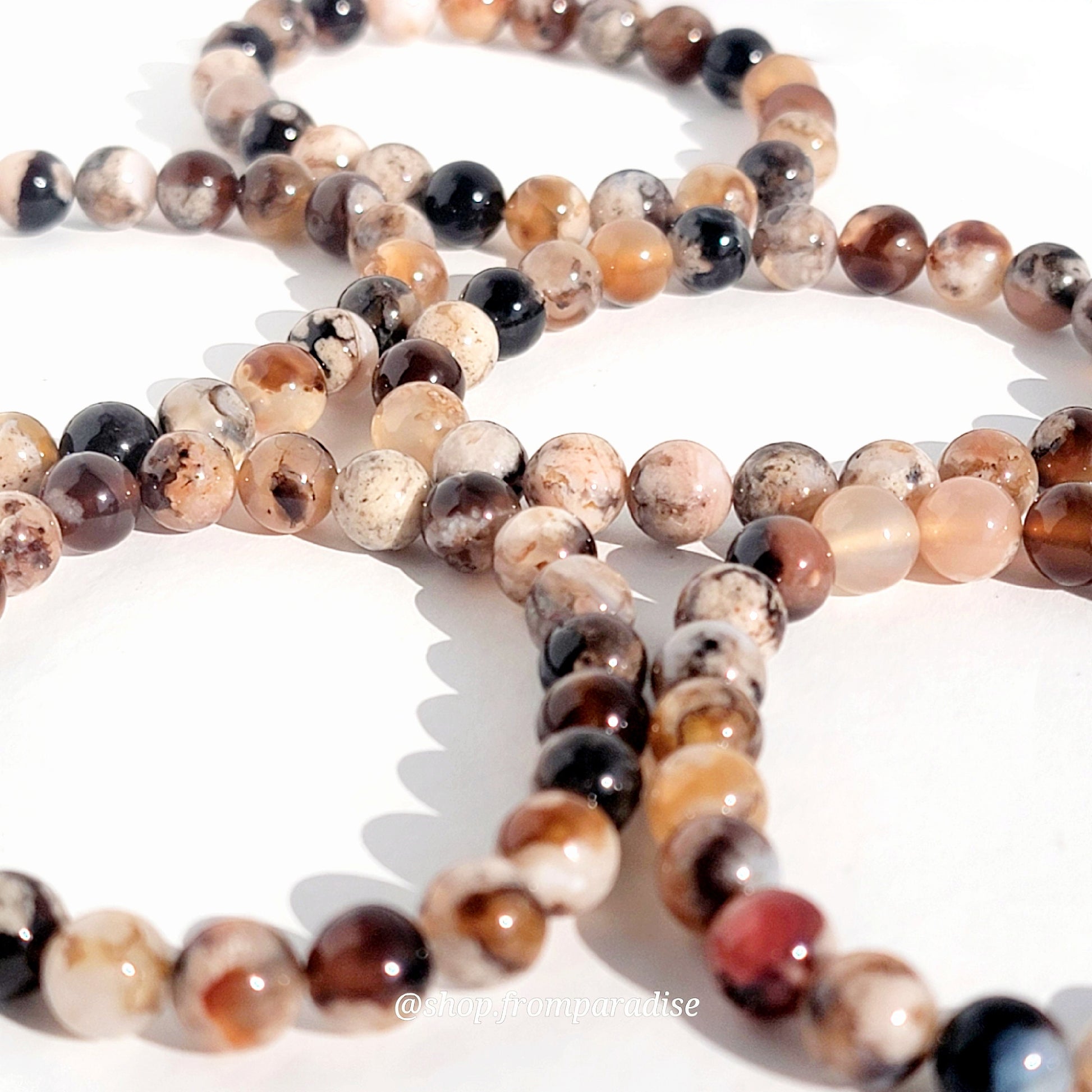 black flower agate crystal bracelets against a white background