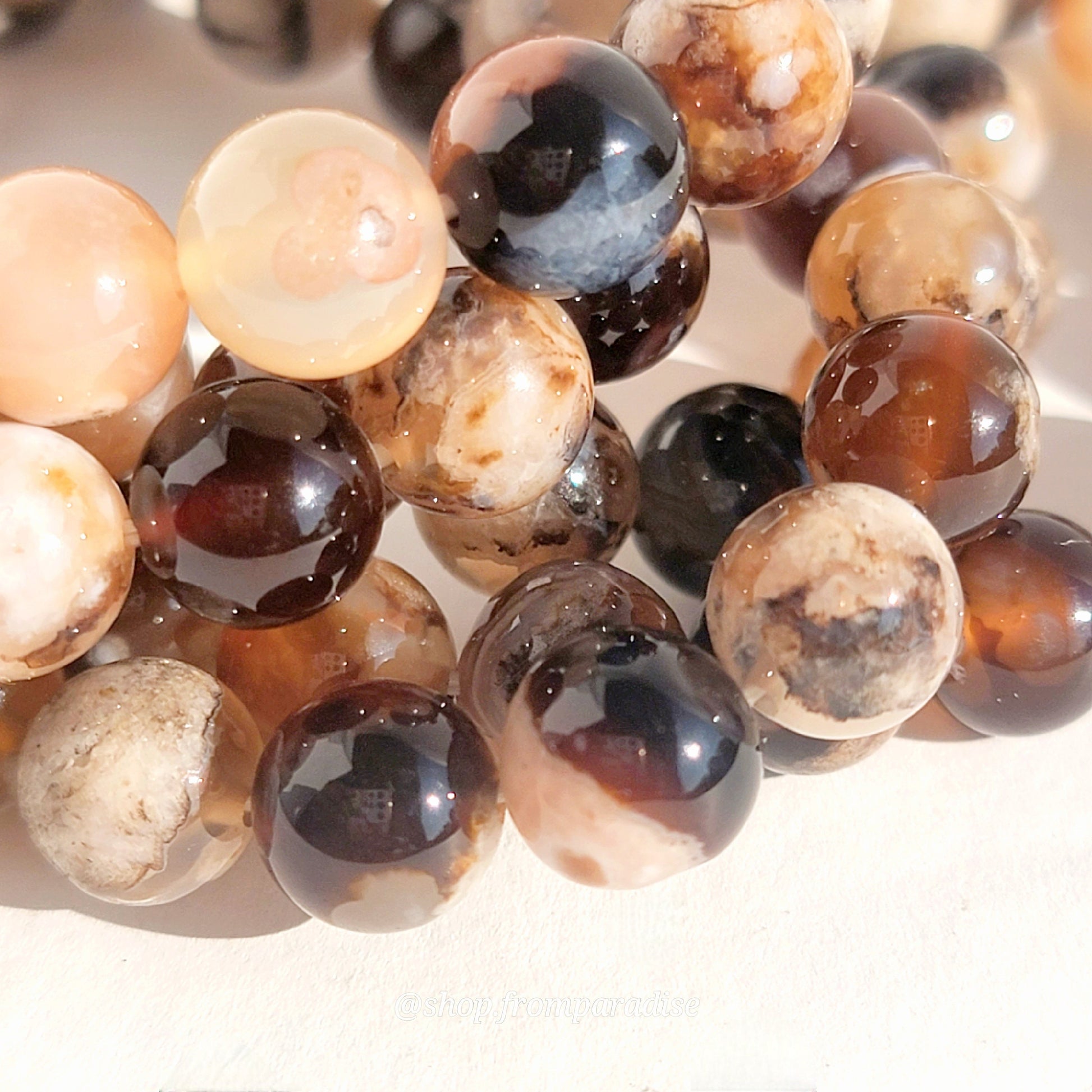 black flower agate crystal bracelets against a white background