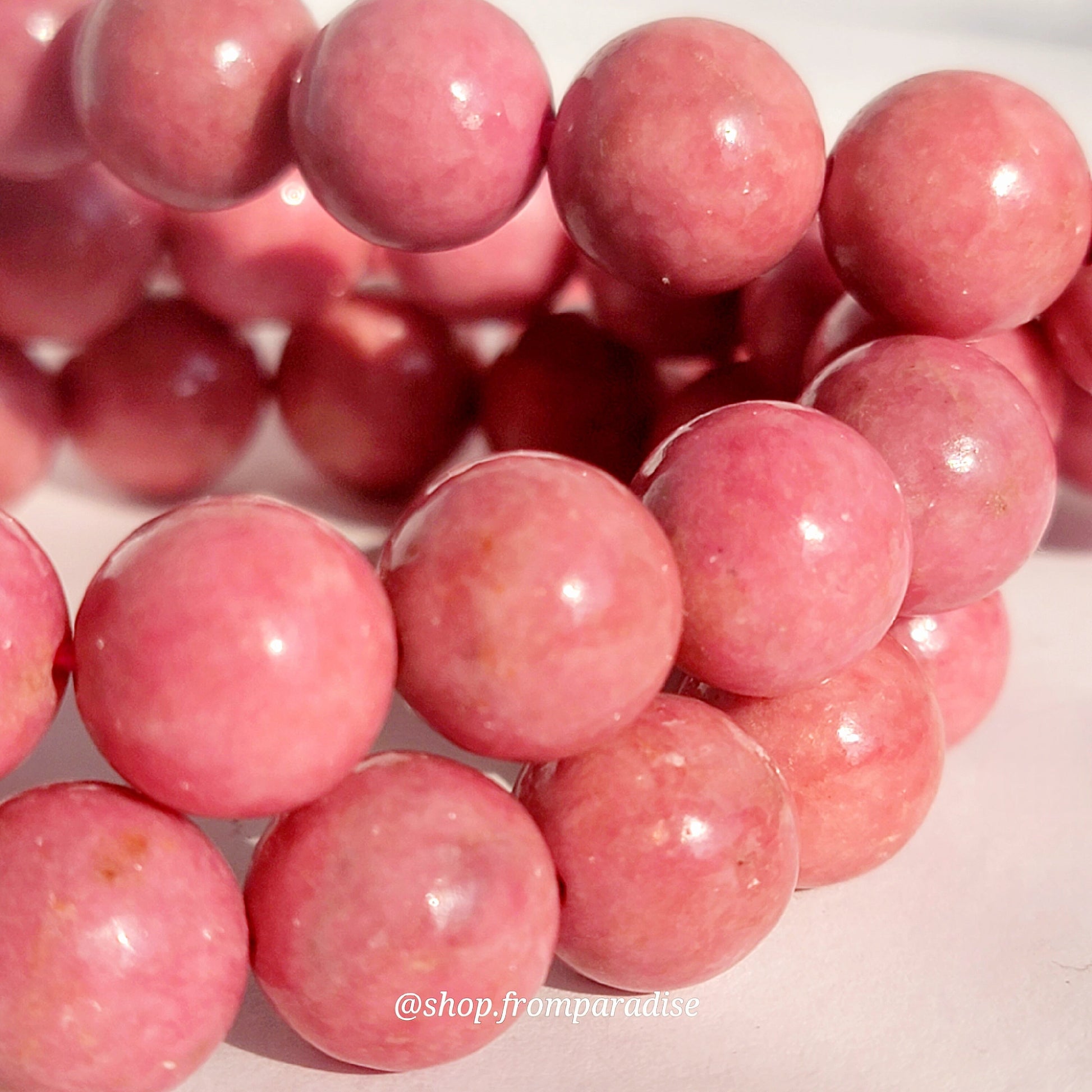 Rhodonite Jewelry crystal bead bracelet close up against a white background