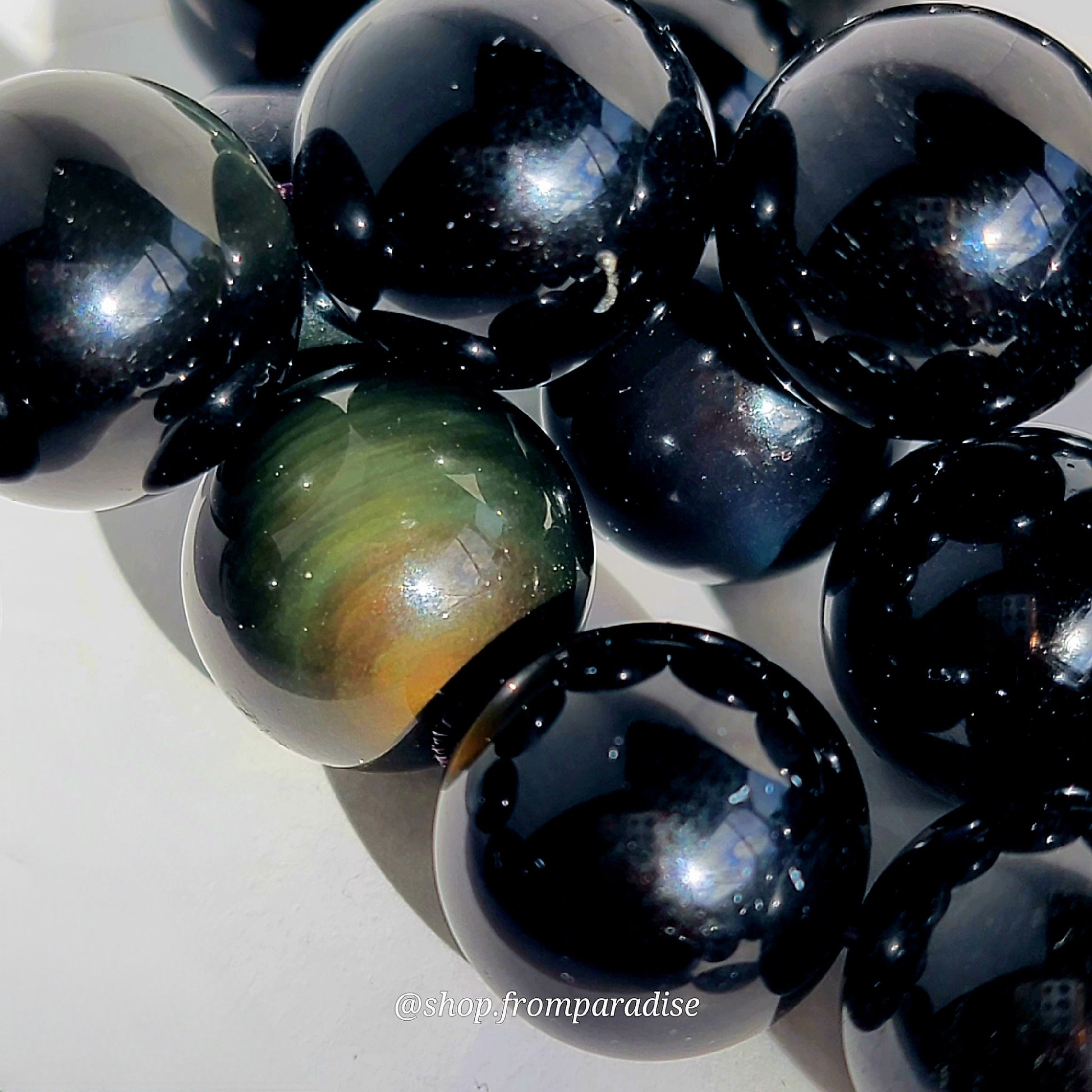 close up of rainbow obsidian beads on diy handmade bracelet