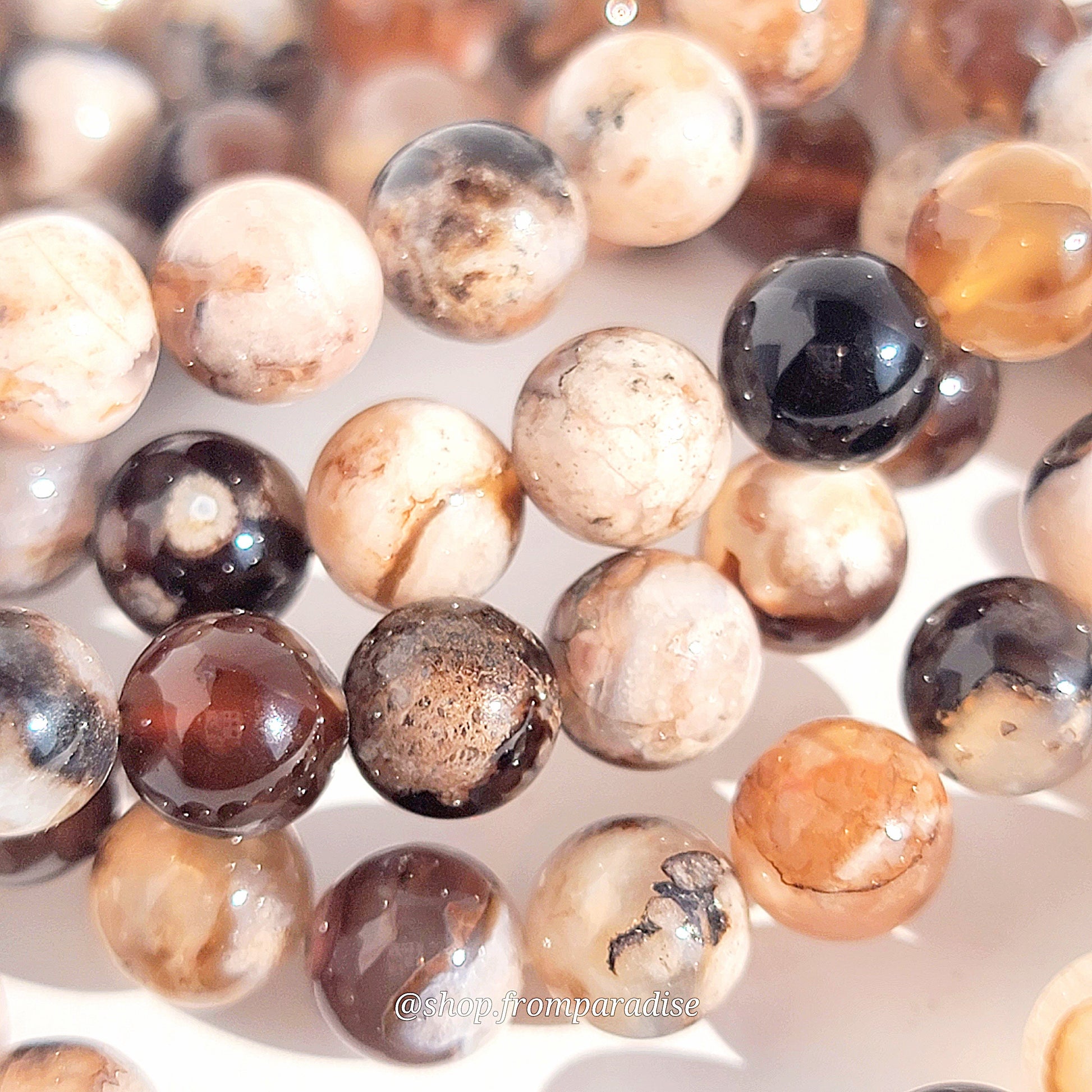black flower agate crystal bracelets against a white background