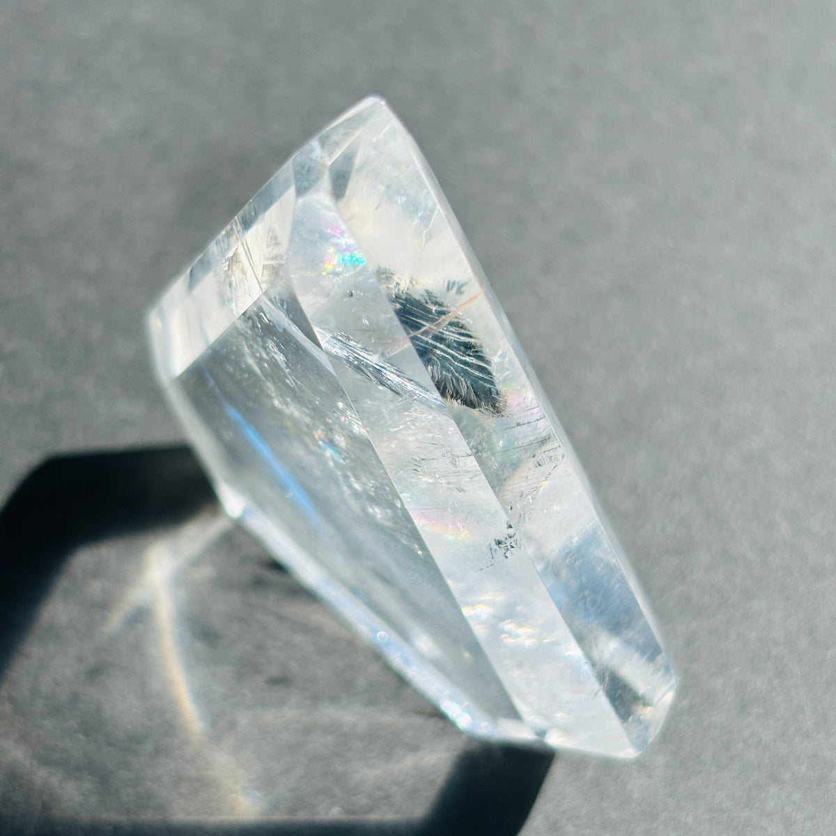 Clear Quartz Crystal Boho Chic Stone Sculpture against a black background