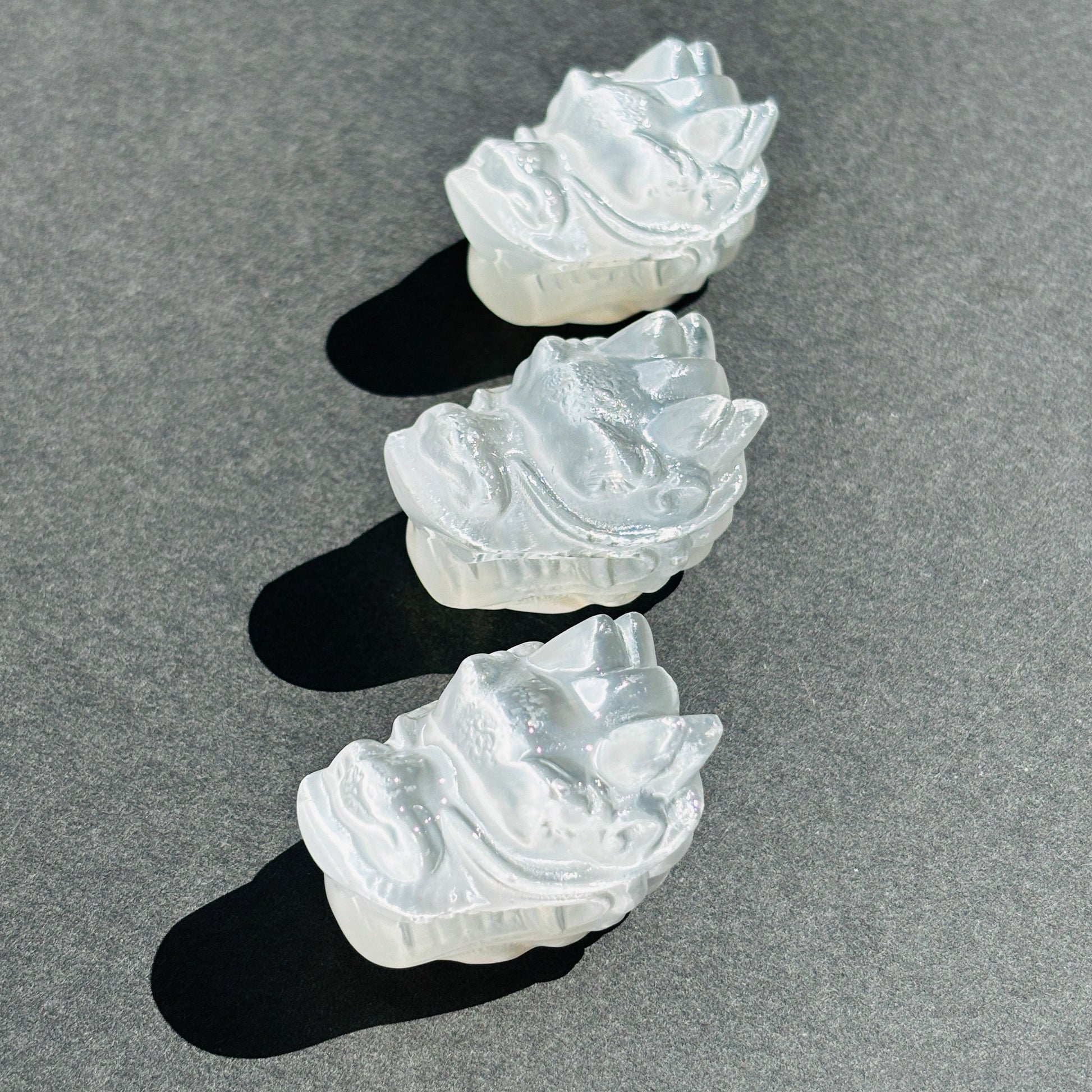 Selenite Oriental Dragon Crystal Sculpture against a black background