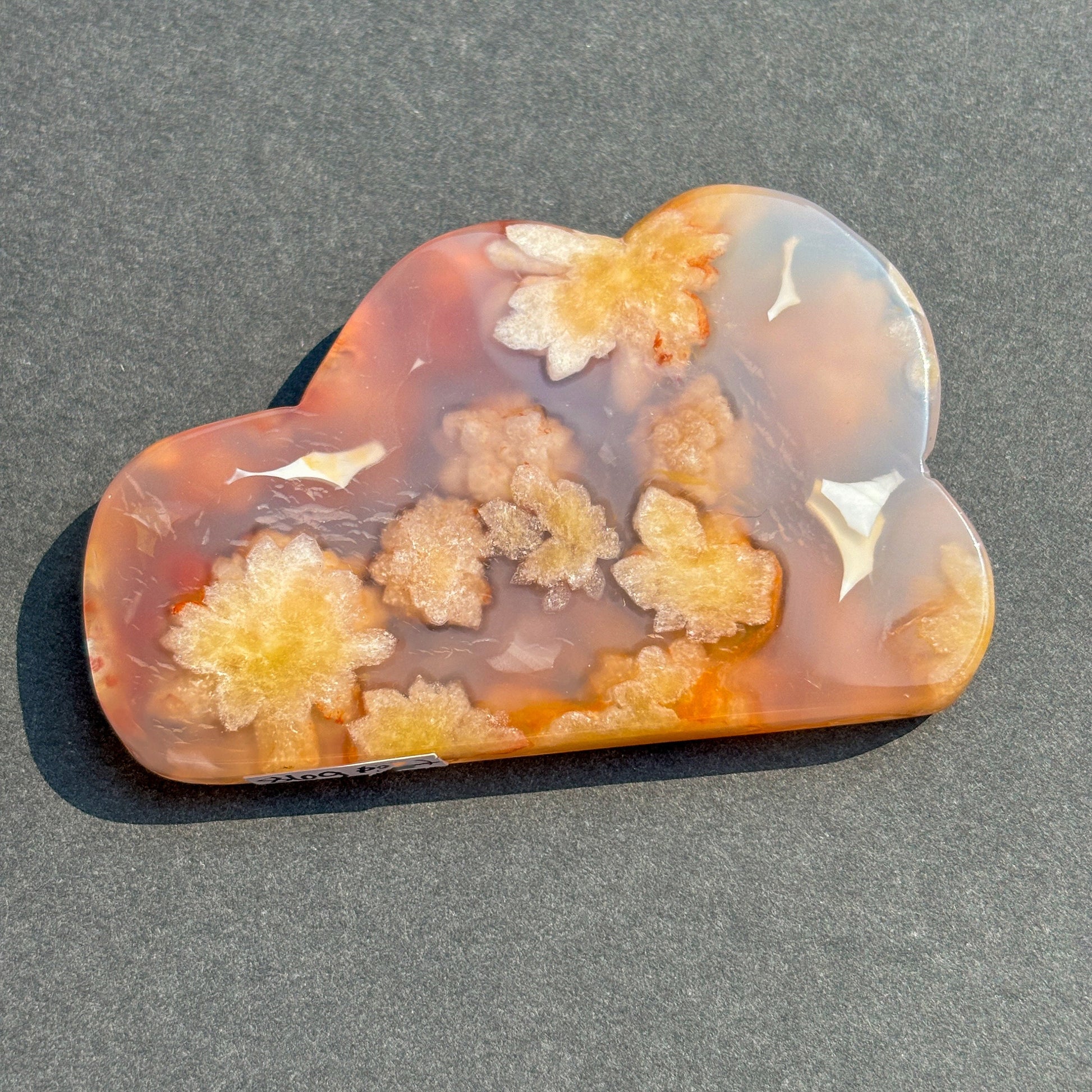 Flower Agate Crystal Cloud Carving Stone Sculpture against a black background