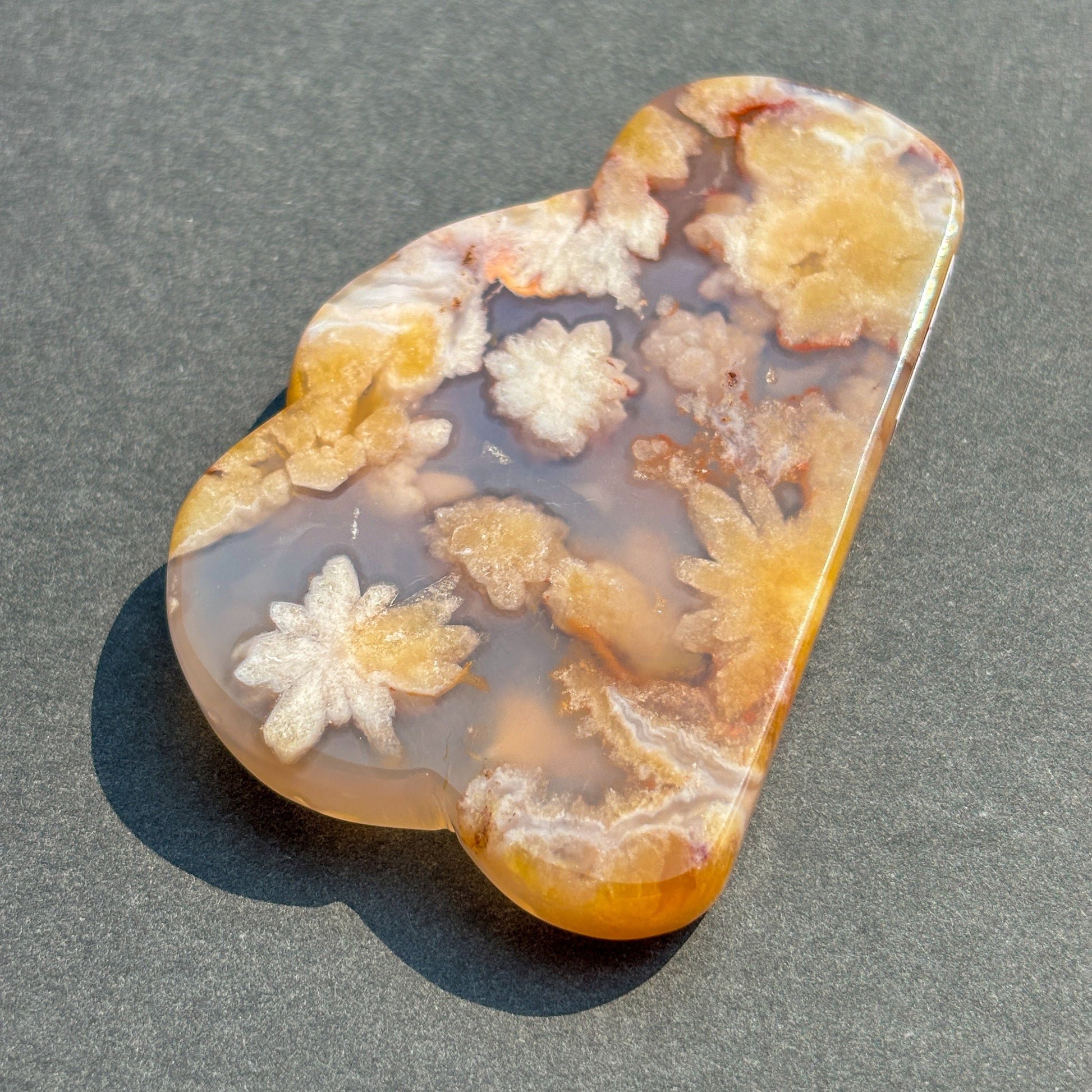 Flower Agate Crystal Cloud Carving Stone Sculpture against a black background