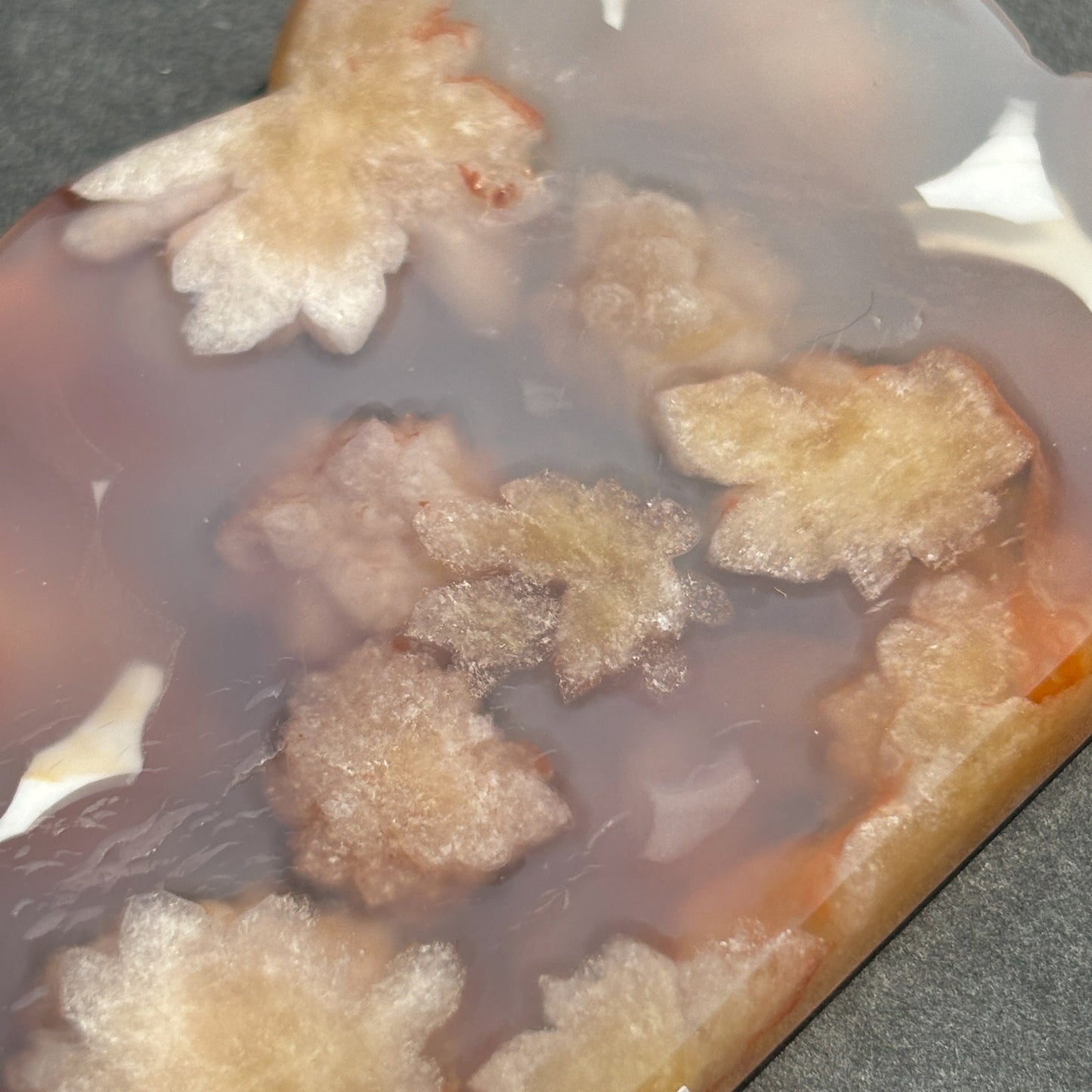 Flower Agate Crystal Cloud Carving Stone Sculpture against a black background
