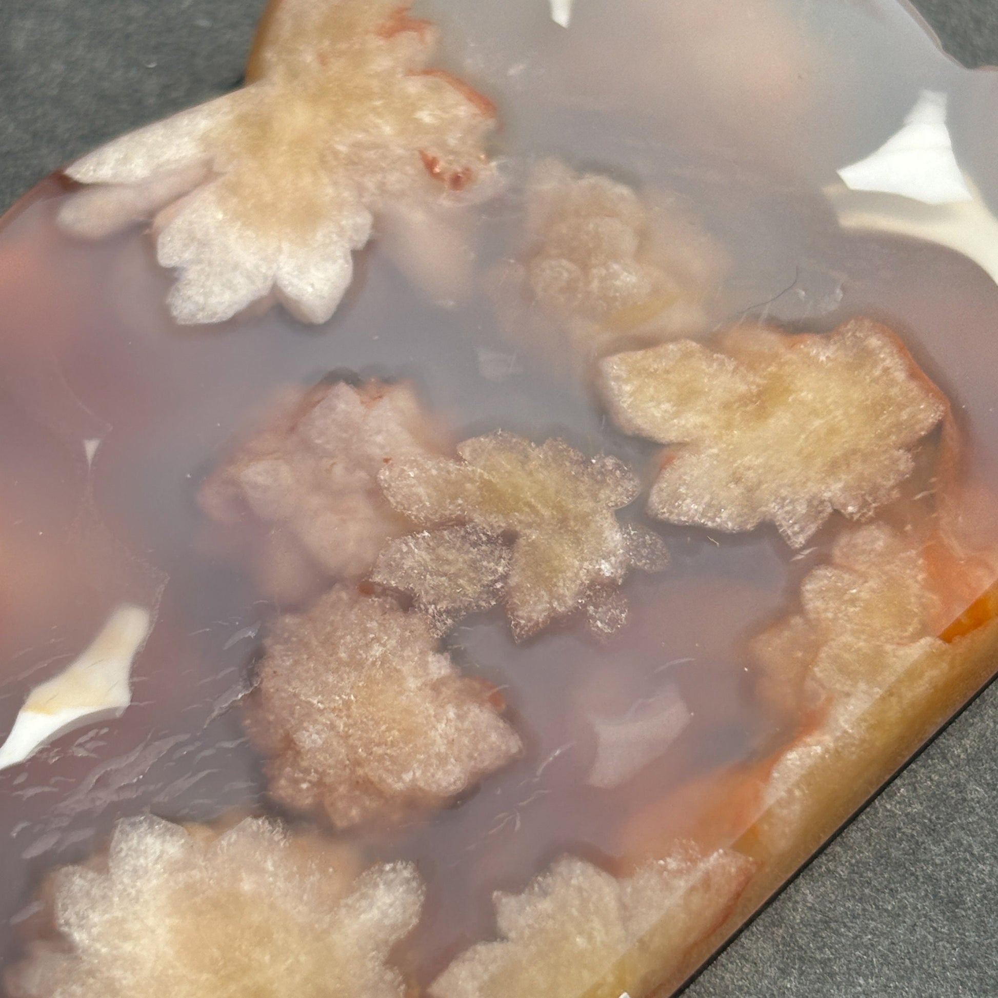 Flower Agate Crystal Cloud Carving Stone Sculpture against a black background