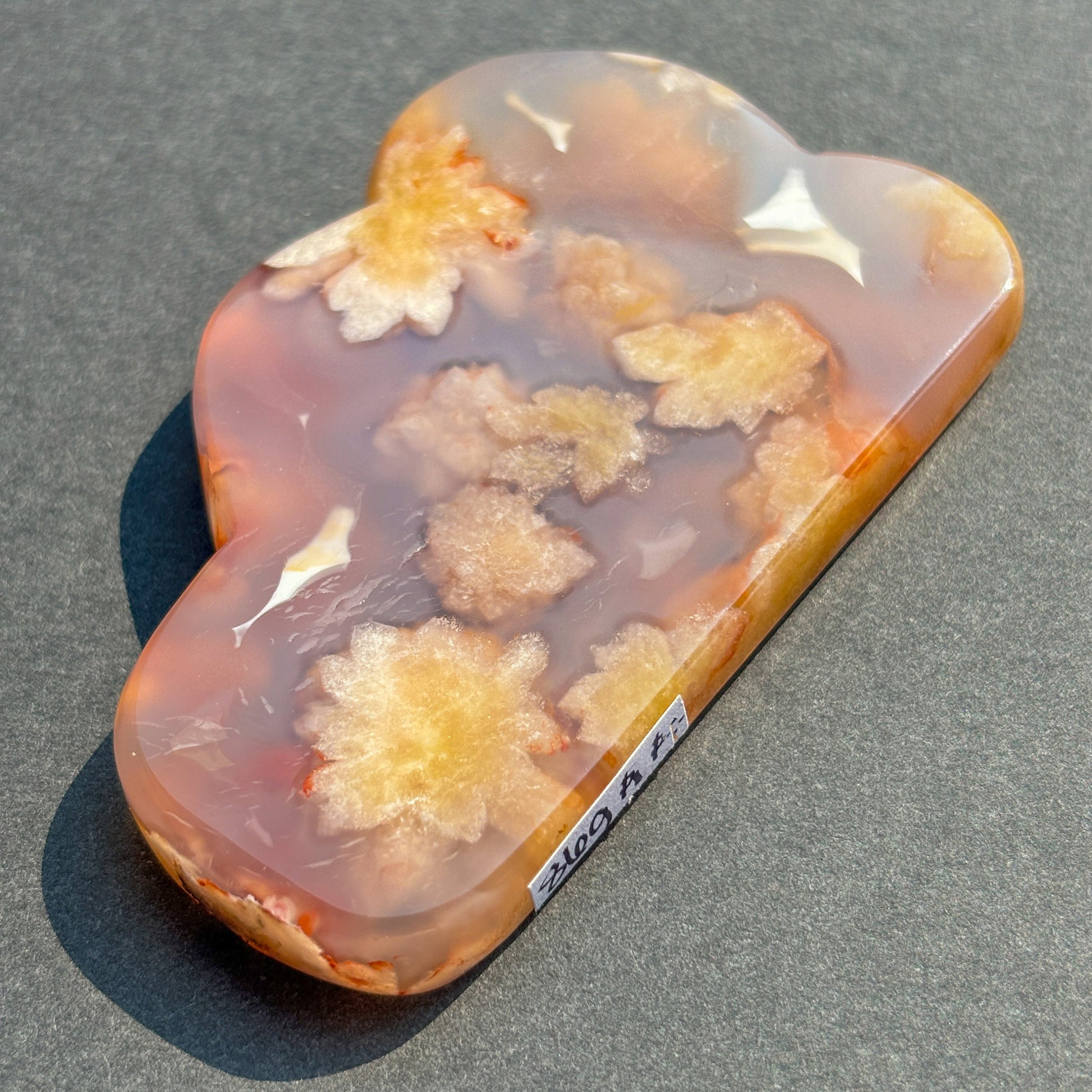 Flower Agate Crystal Cloud Carving Stone Sculpture against a black background