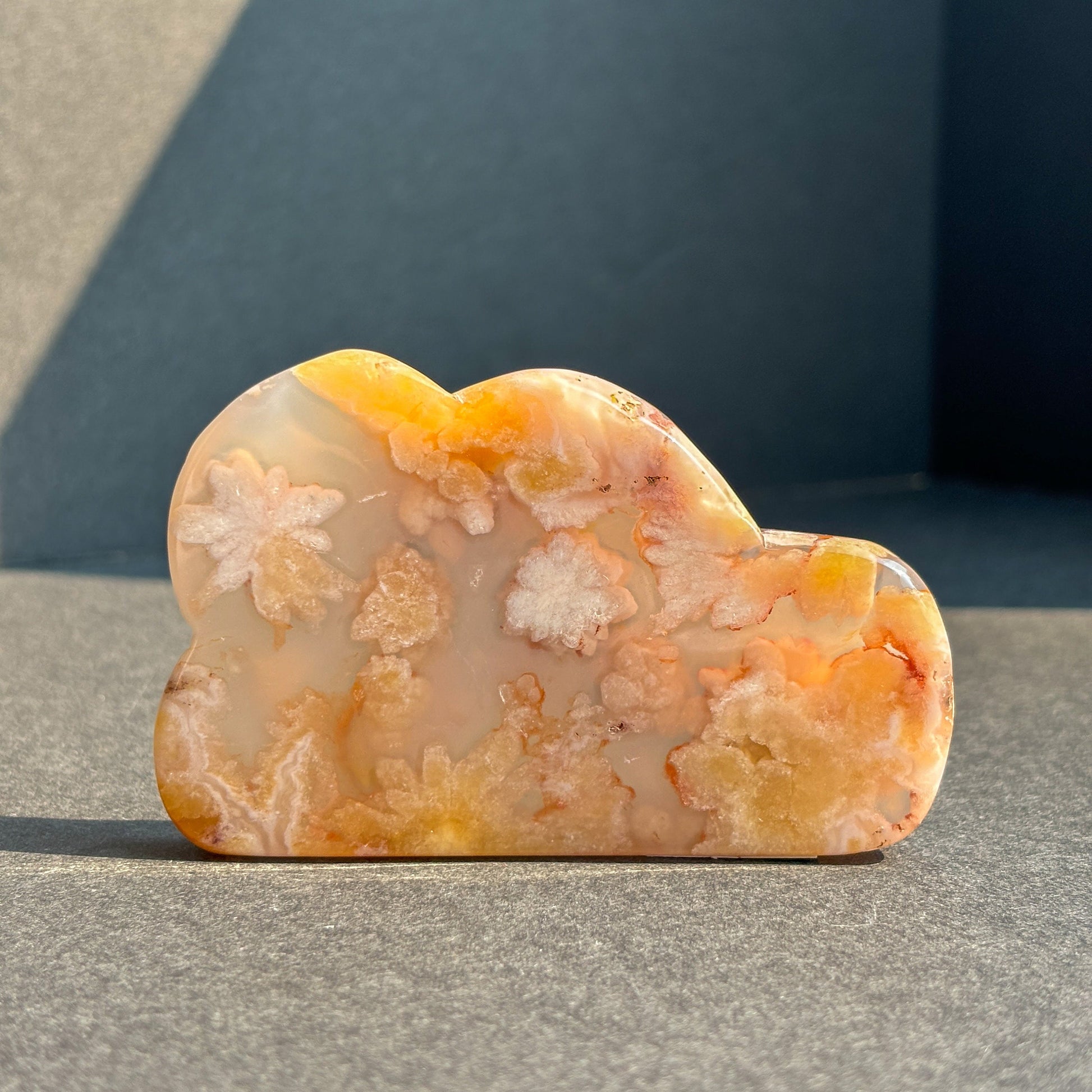 Flower Agate Crystal Cloud Carving Stone Sculpture against a black background