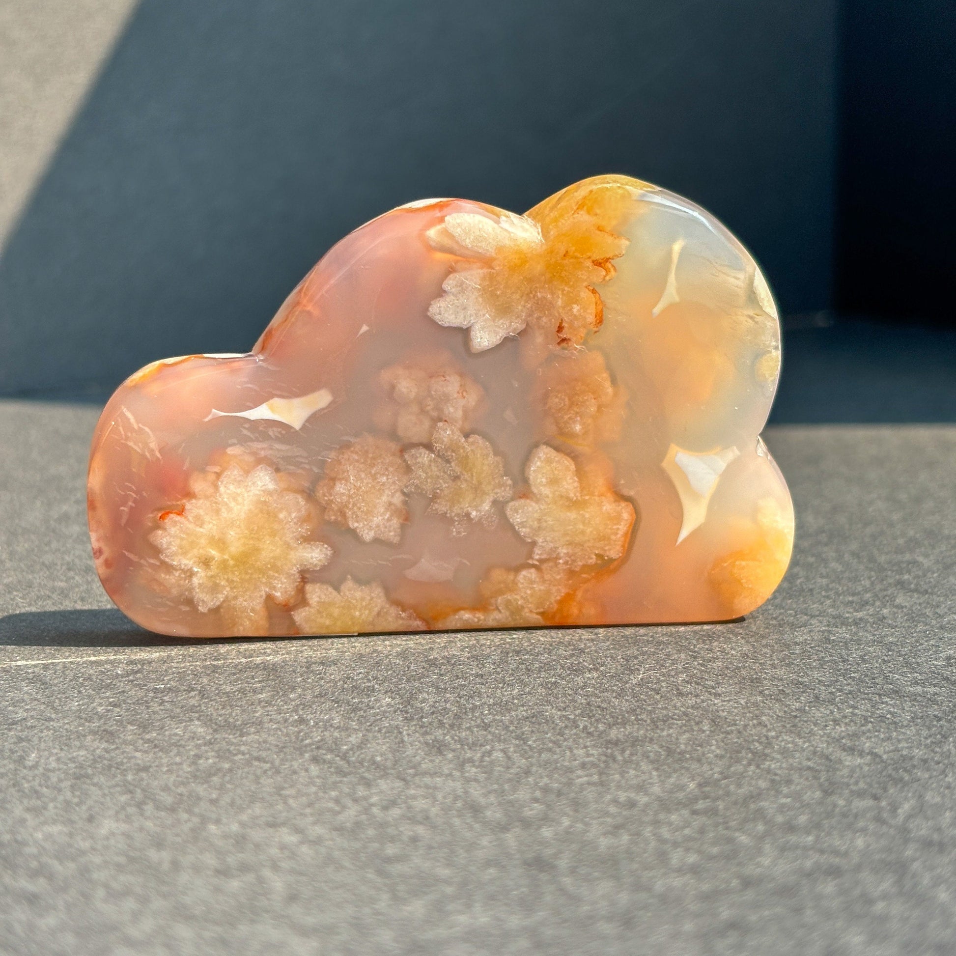 Flower Agate Crystal Cloud Carving Stone Sculpture against a black background