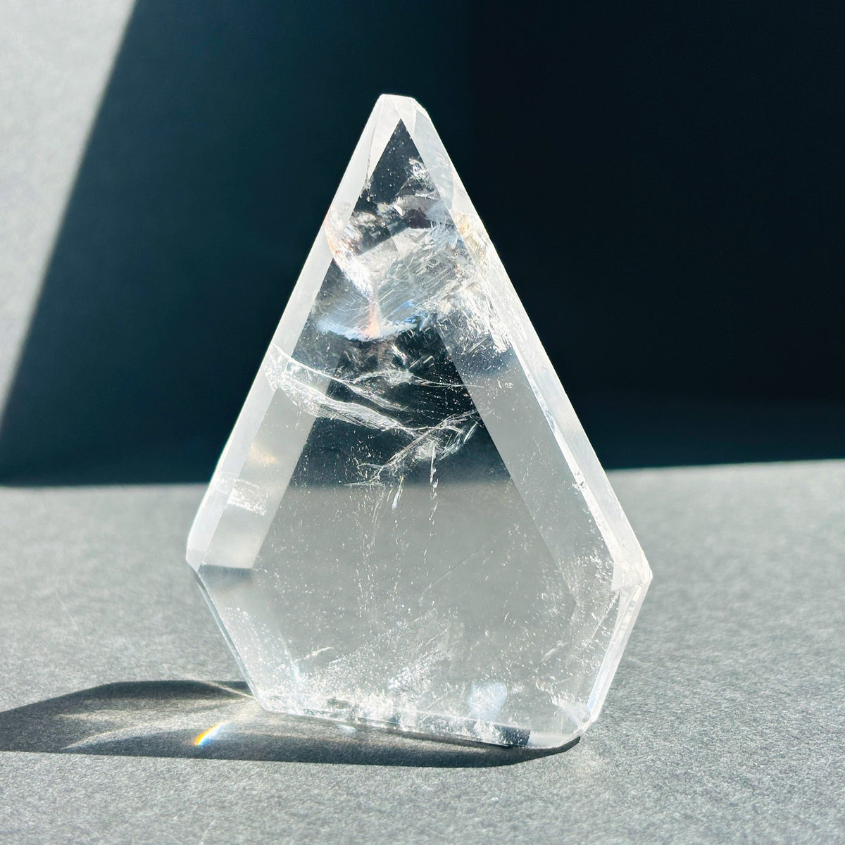 Clear Quartz Crystal Boho Chic Stone Sculpture against a black background