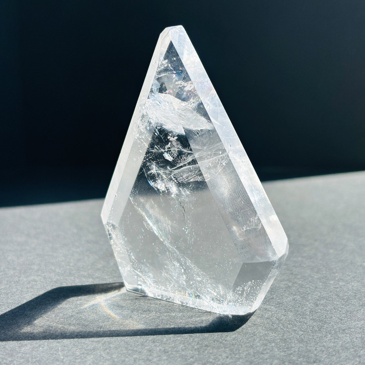Clear Quartz Crystal Boho Chic Stone Sculpture against a black background