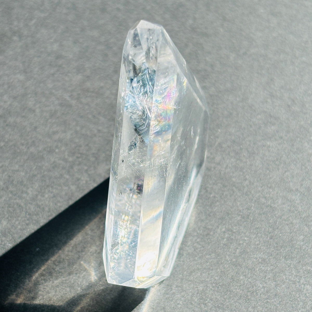 Clear Quartz Crystal Boho Chic Stone Sculpture against a black background