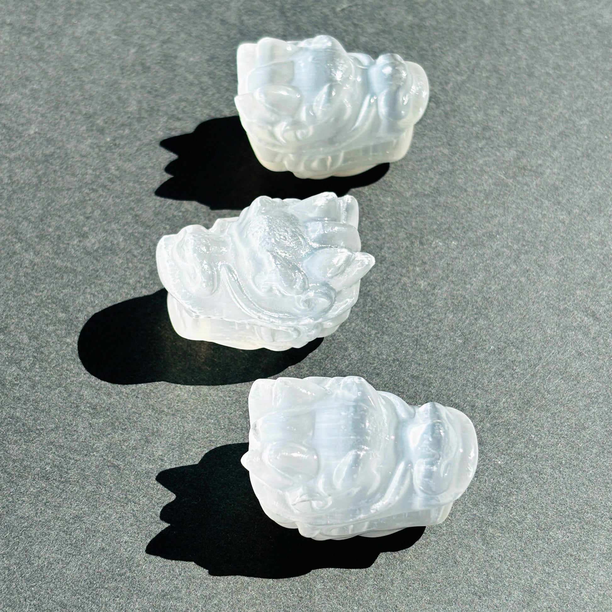 Selenite Oriental Dragon Crystal Sculpture against a black background