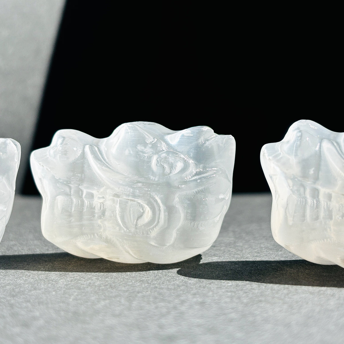 Selenite Oriental Dragon Crystal Sculpture against a black background