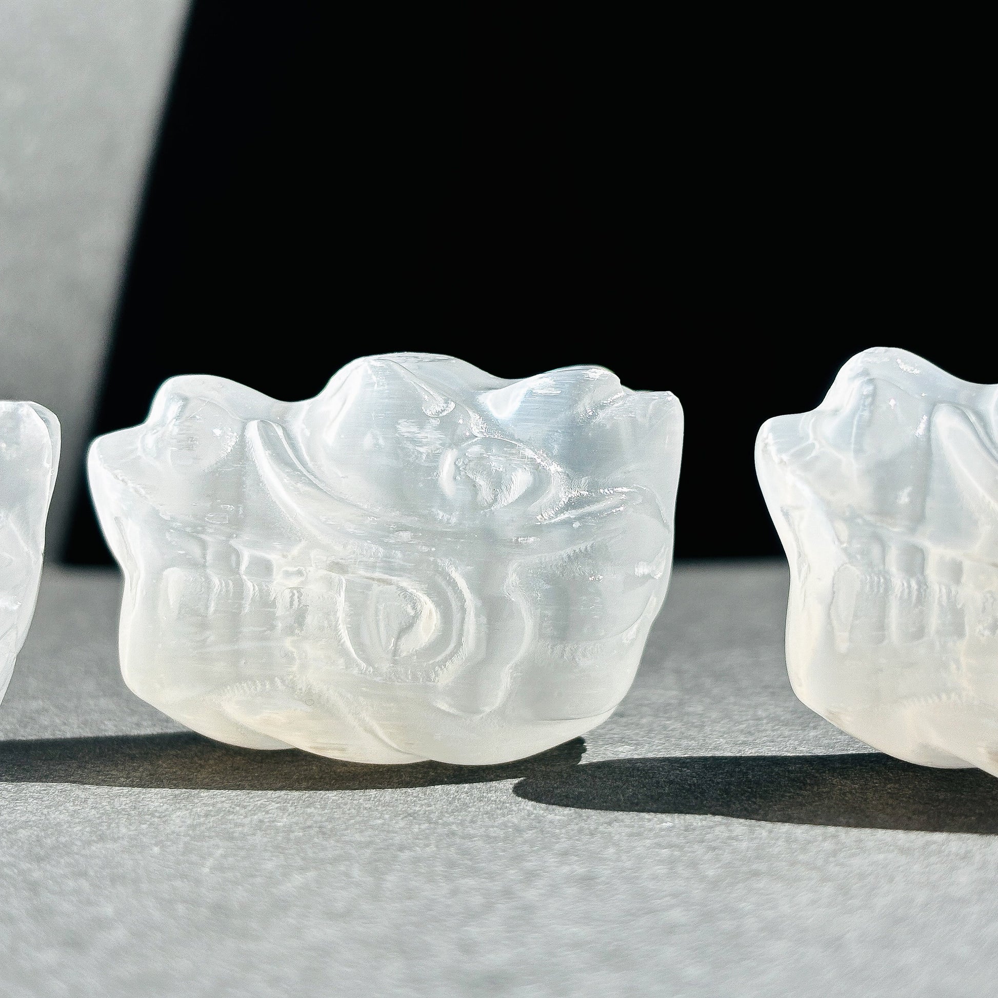 Selenite Oriental Dragon Crystal Sculpture against a black background