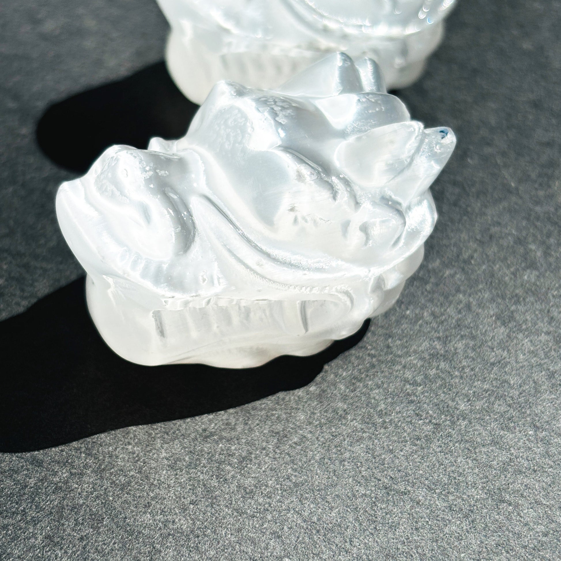 Selenite Oriental Dragon Crystal Sculpture against a black background