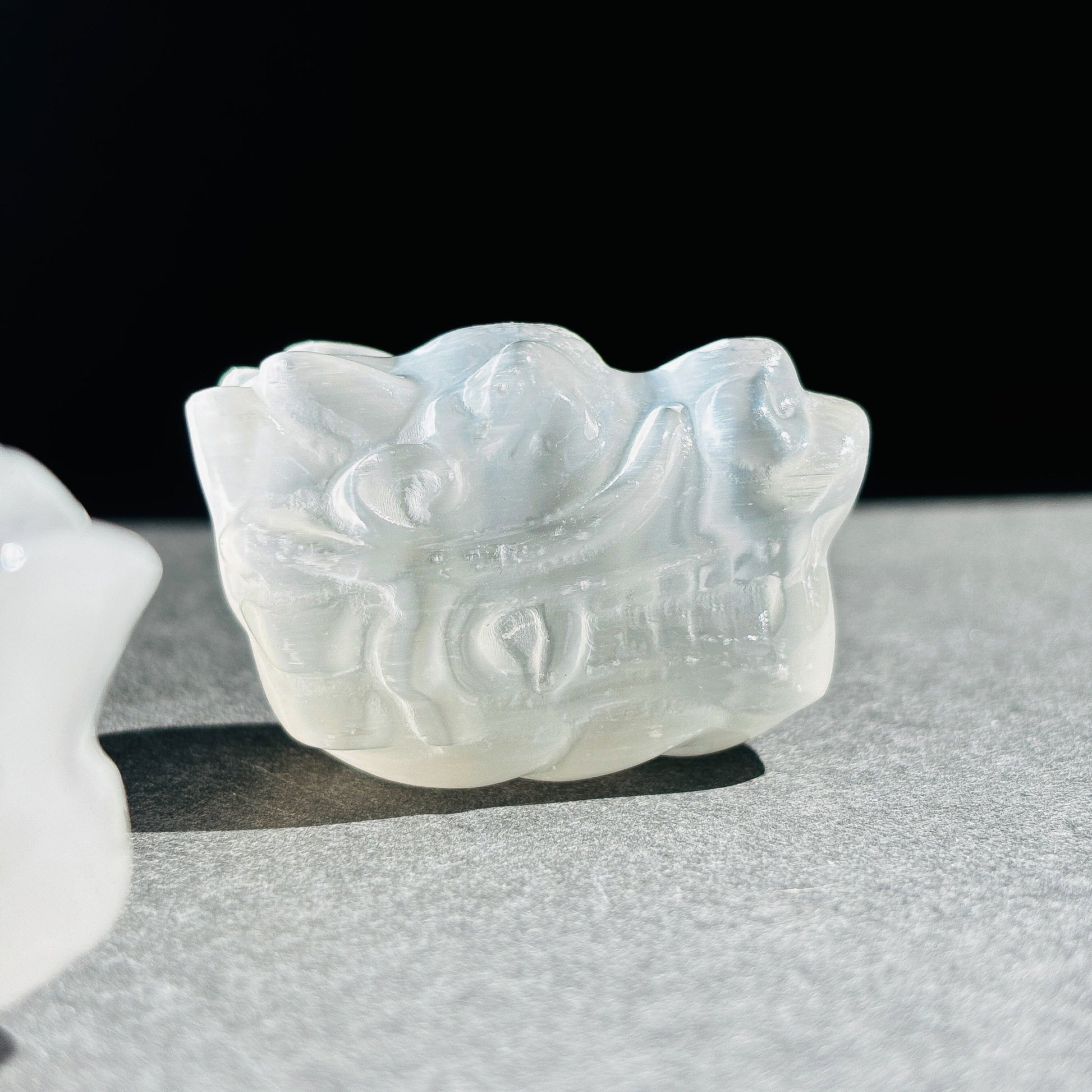 Selenite Oriental Dragon Crystal Sculpture against a black background