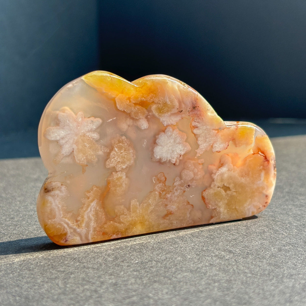 Flower Agate Crystal Cloud Carving Stone Sculpture against a black background