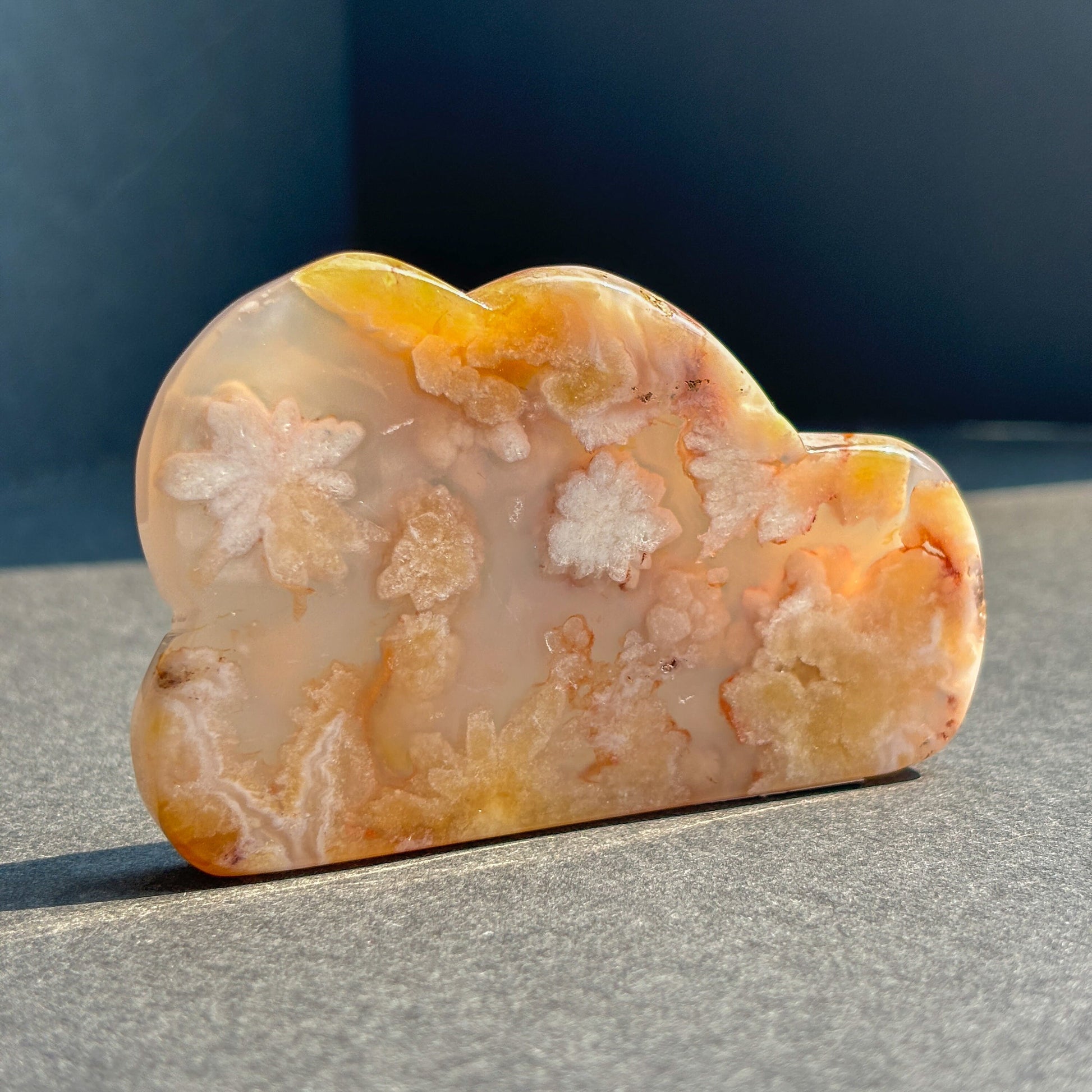 Flower Agate Crystal Cloud Carving Stone Sculpture against a black background