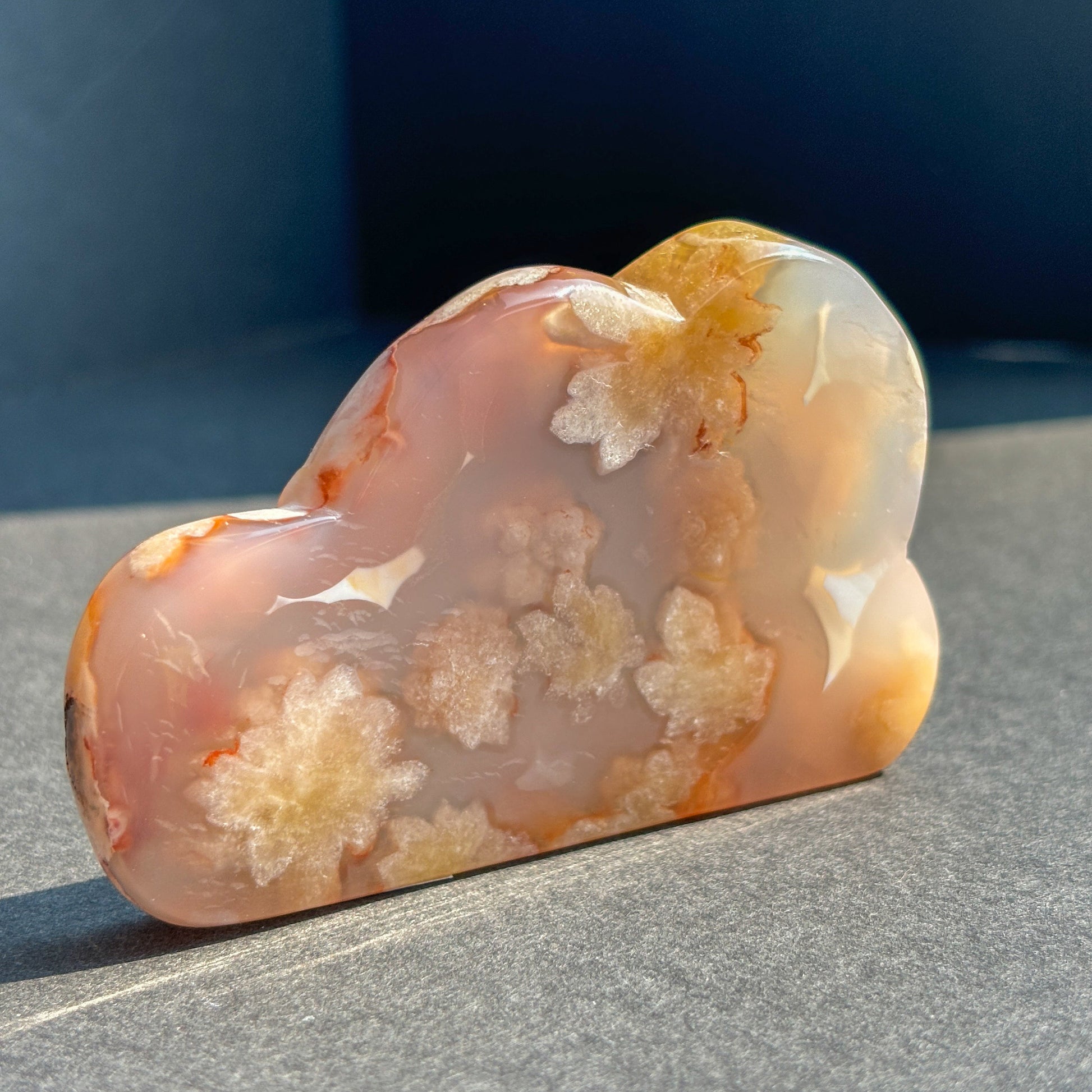 Flower Agate Crystal Cloud Carving Stone Sculpture against a black background