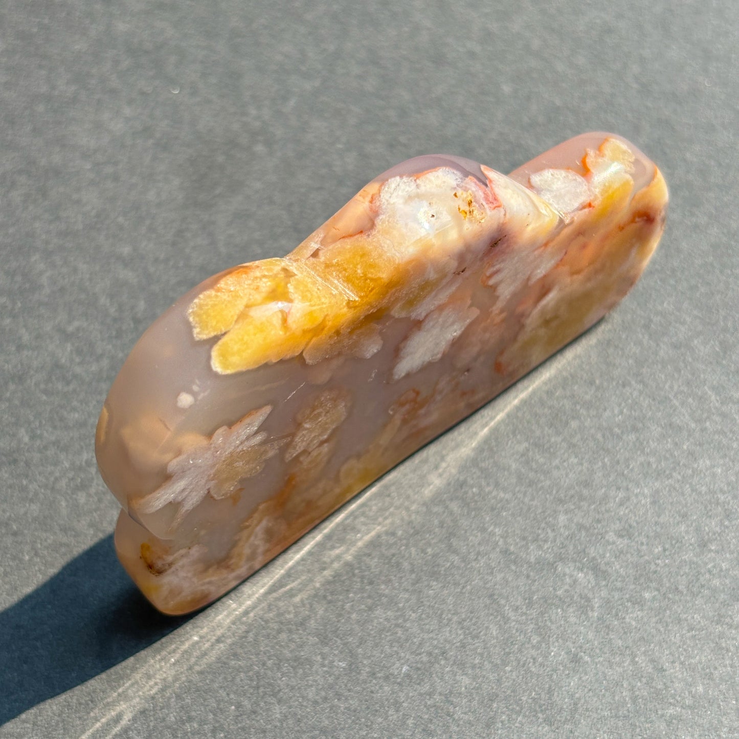 Flower Agate Crystal Cloud Carving Stone Sculpture against a black background