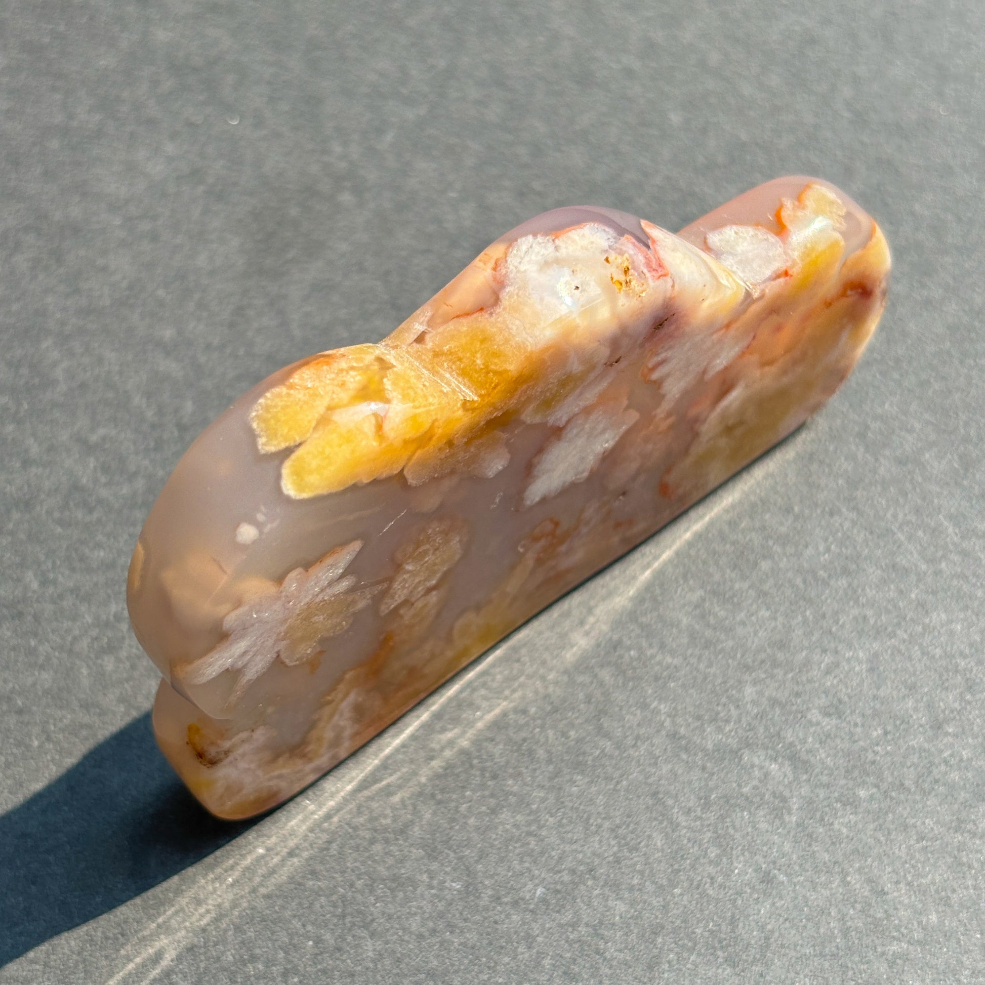 Flower Agate Crystal Cloud Carving Stone Sculpture against a black background