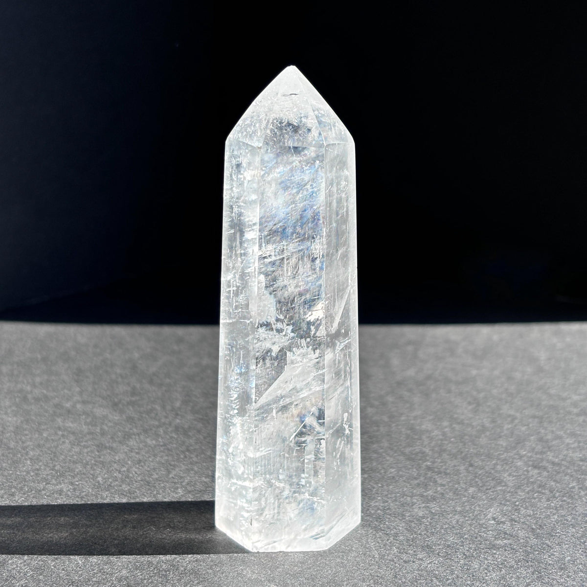 Optical Calcite Crystal Tower against a black background