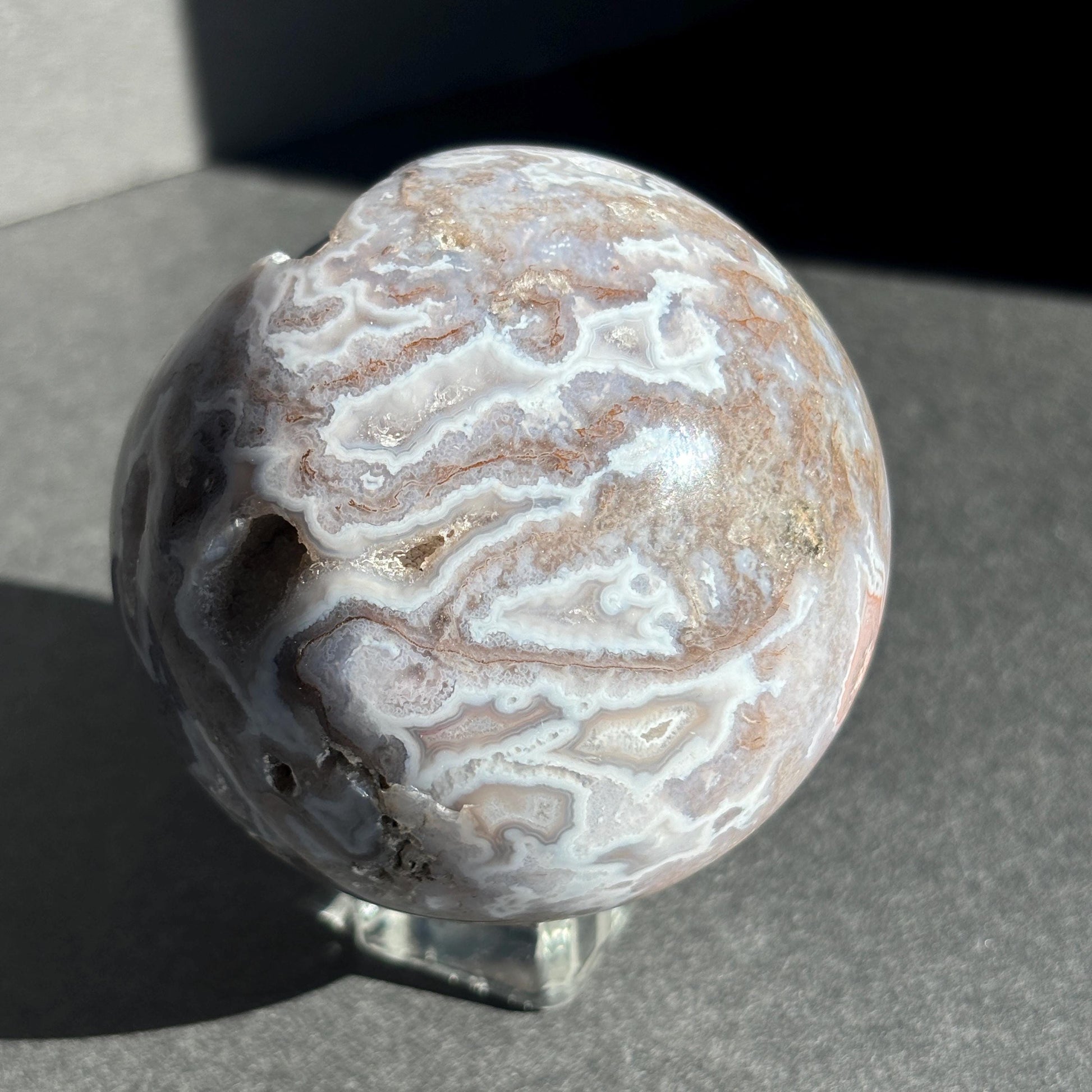 Druzy Pink Moss Agate Crystal Sphere against a black background