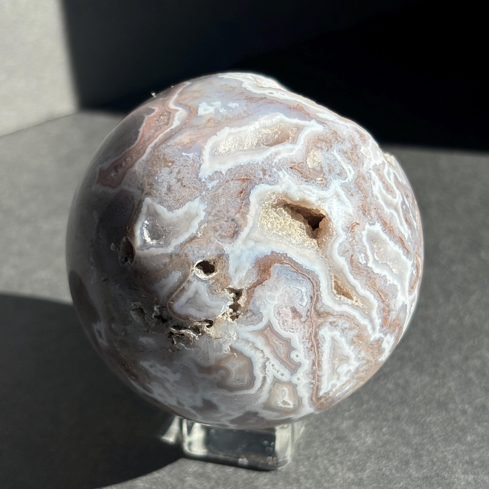 Druzy Pink Moss Agate Crystal Sphere against a black background
