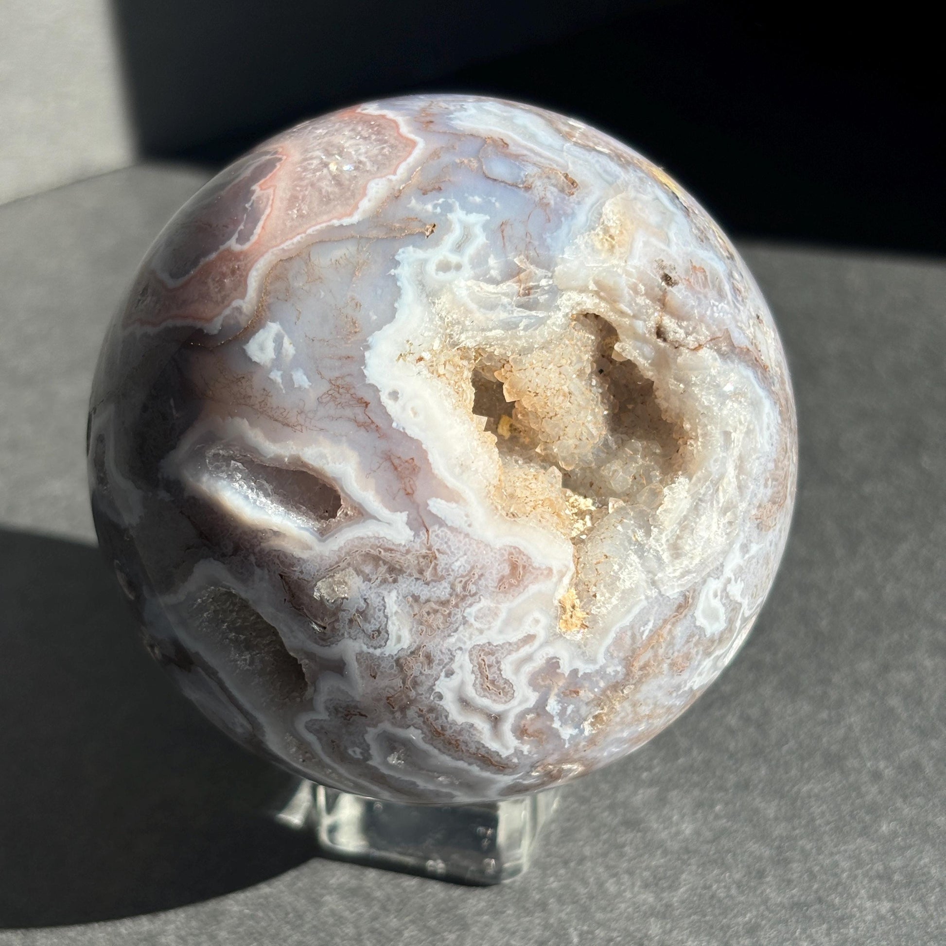 Druzy Pink Moss Agate Crystal Sphere against a black background