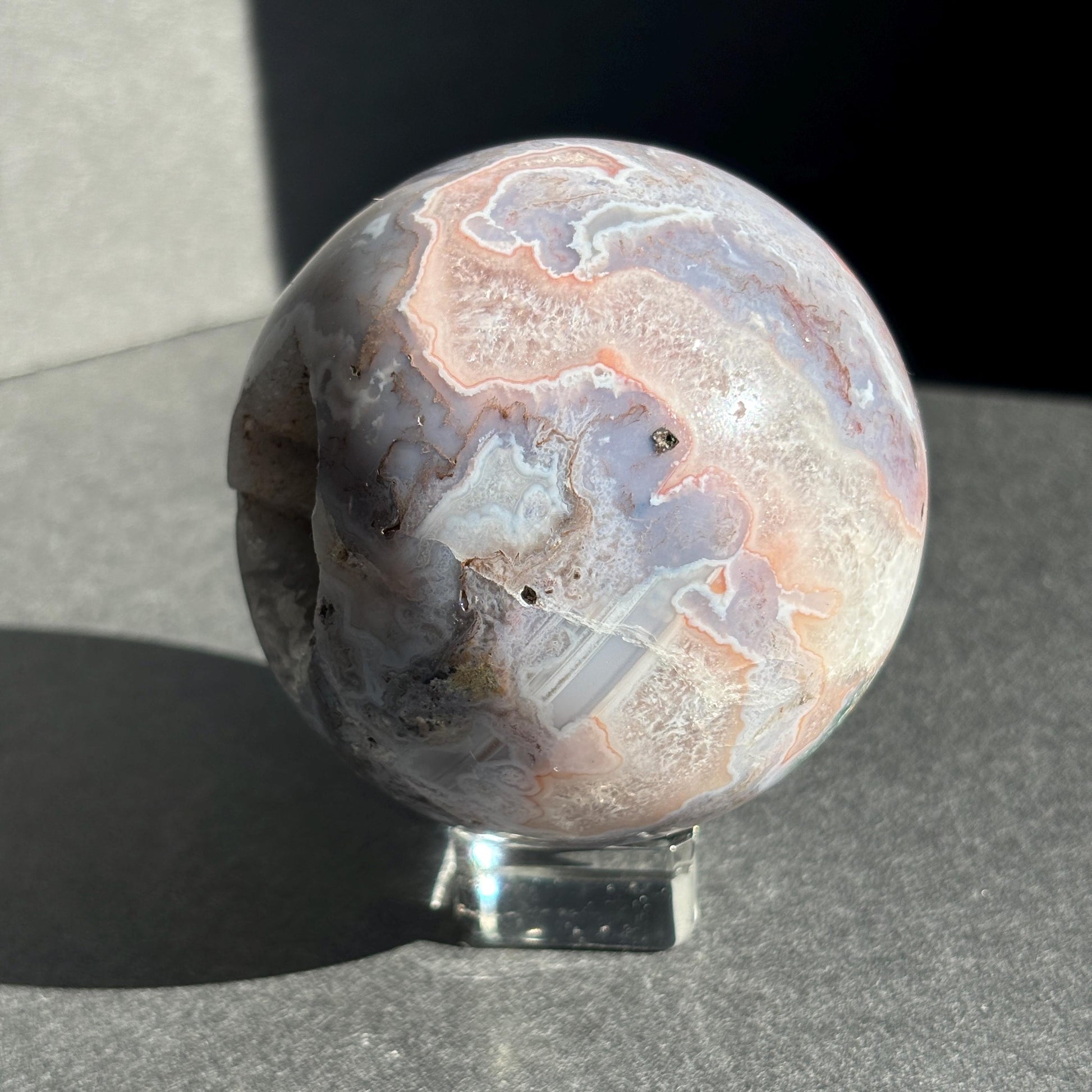 Druzy Pink Moss Agate Crystal Sphere against a black background