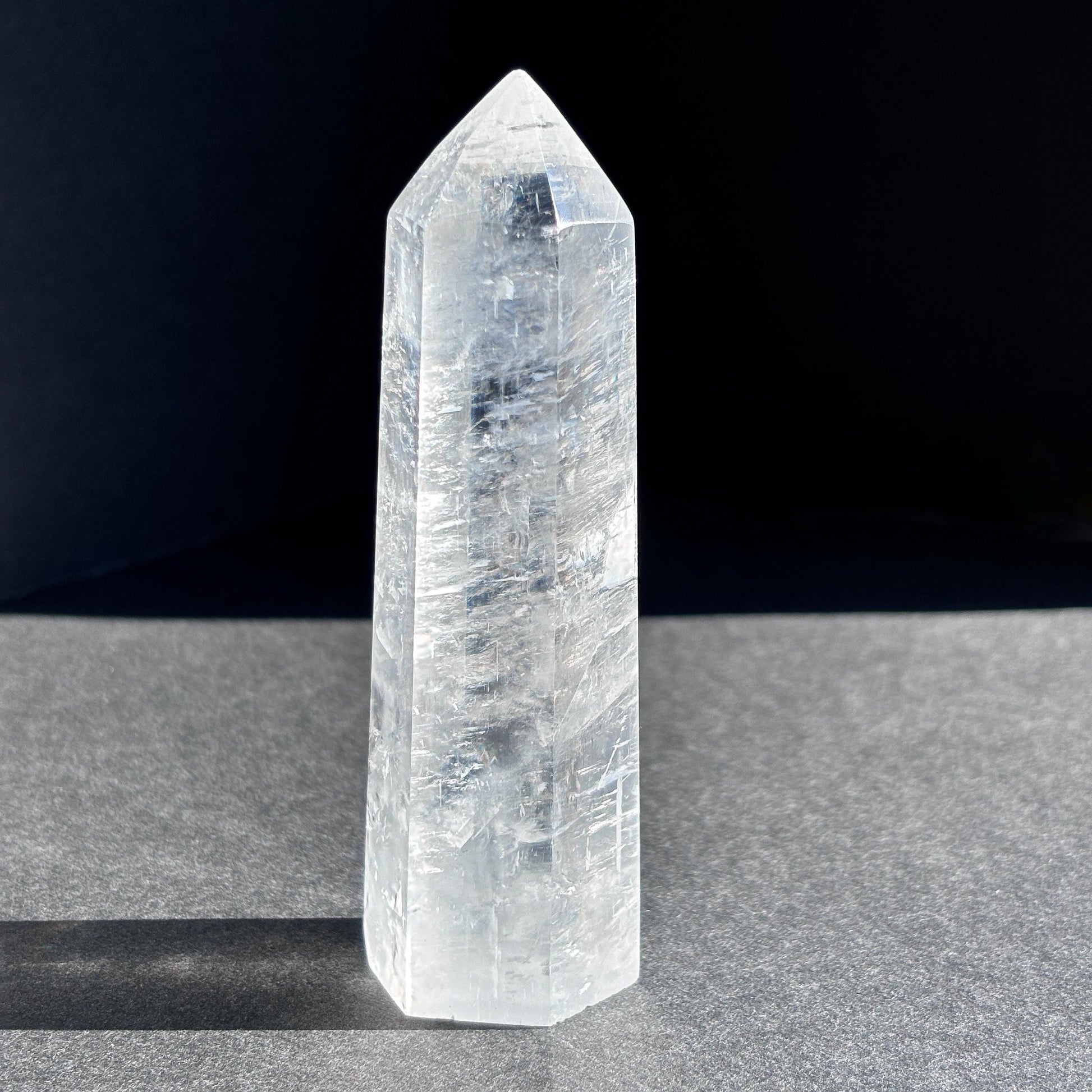 Optical Calcite Crystal Tower against a black background