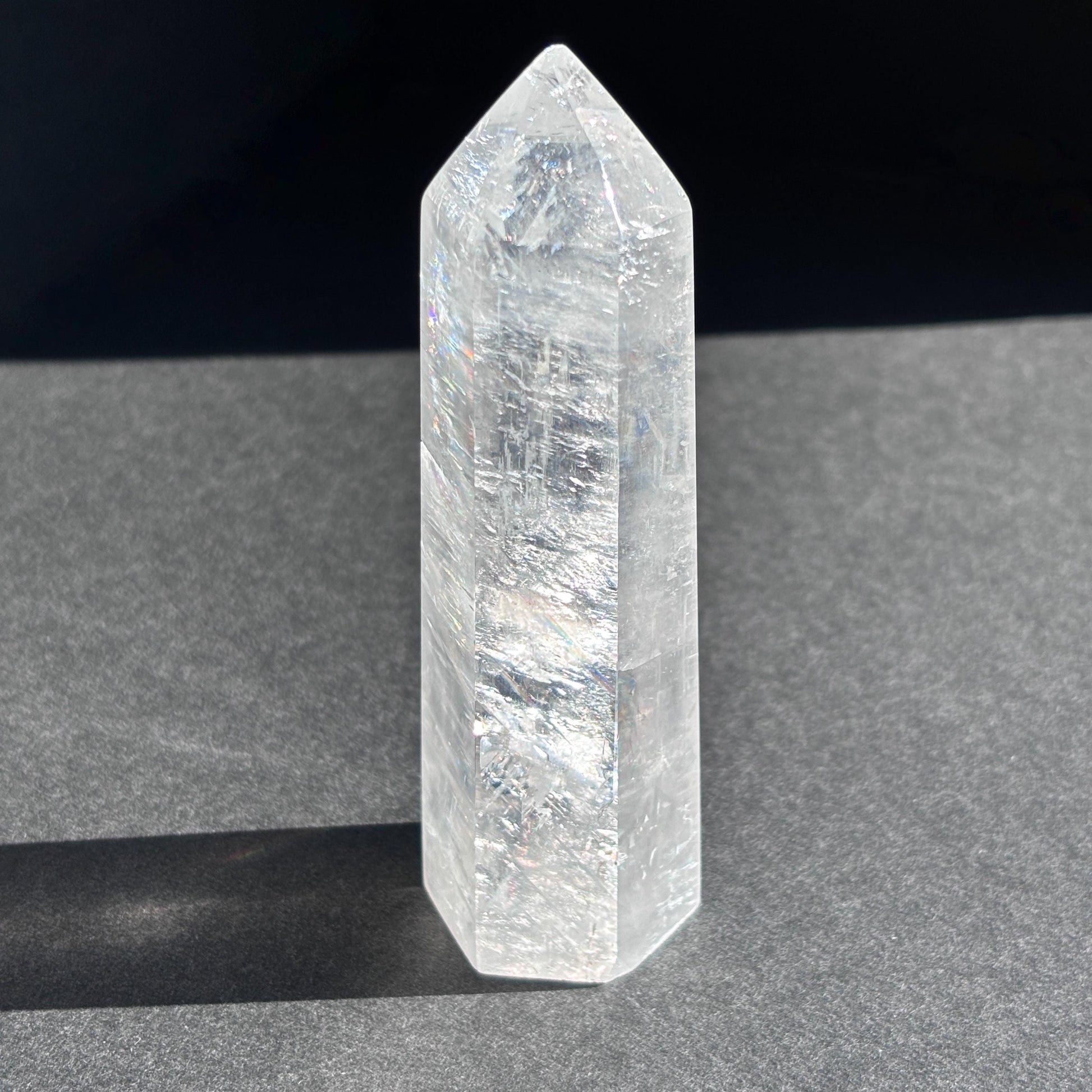 Optical Calcite Crystal Tower against a black background