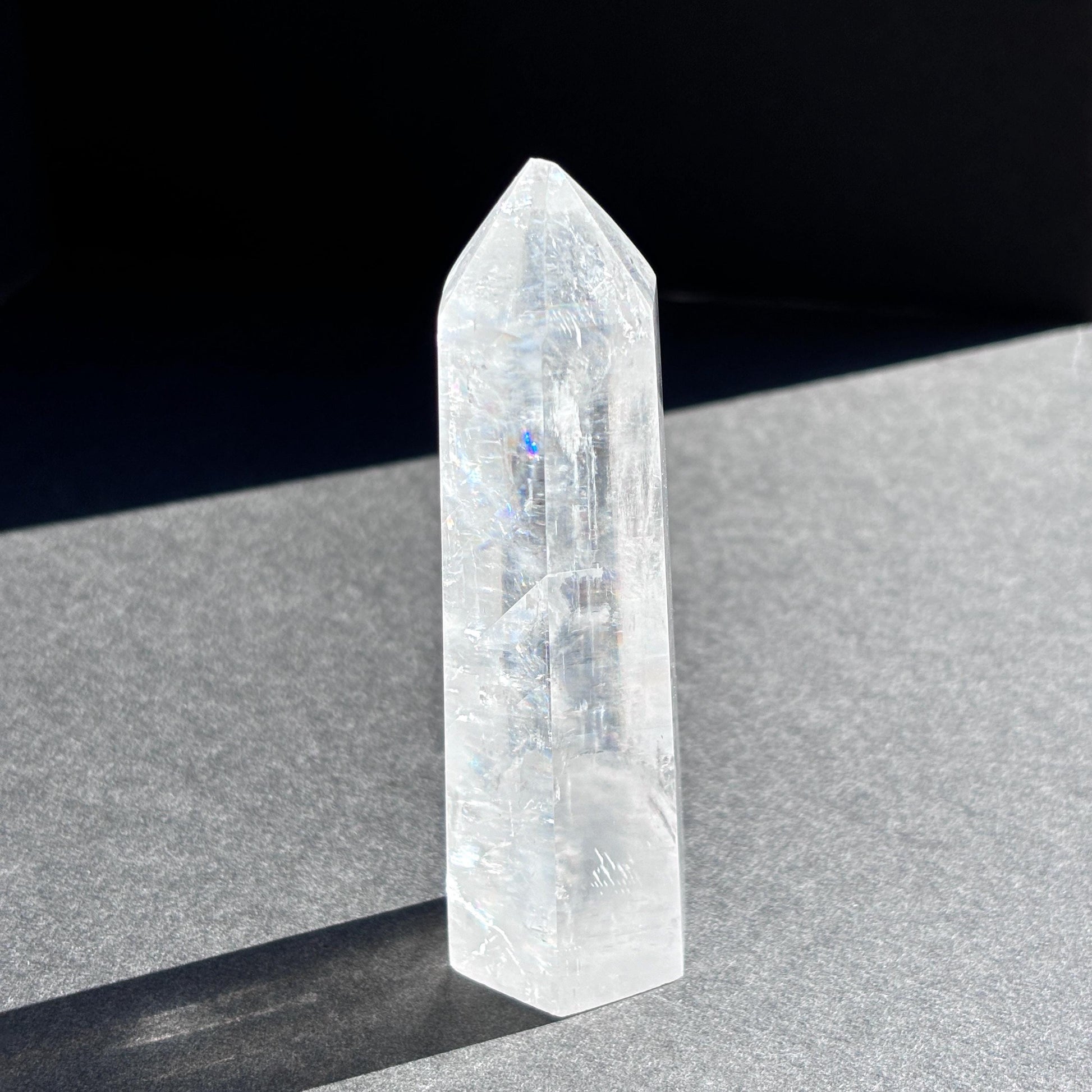 Optical Calcite Crystal Tower against a black background