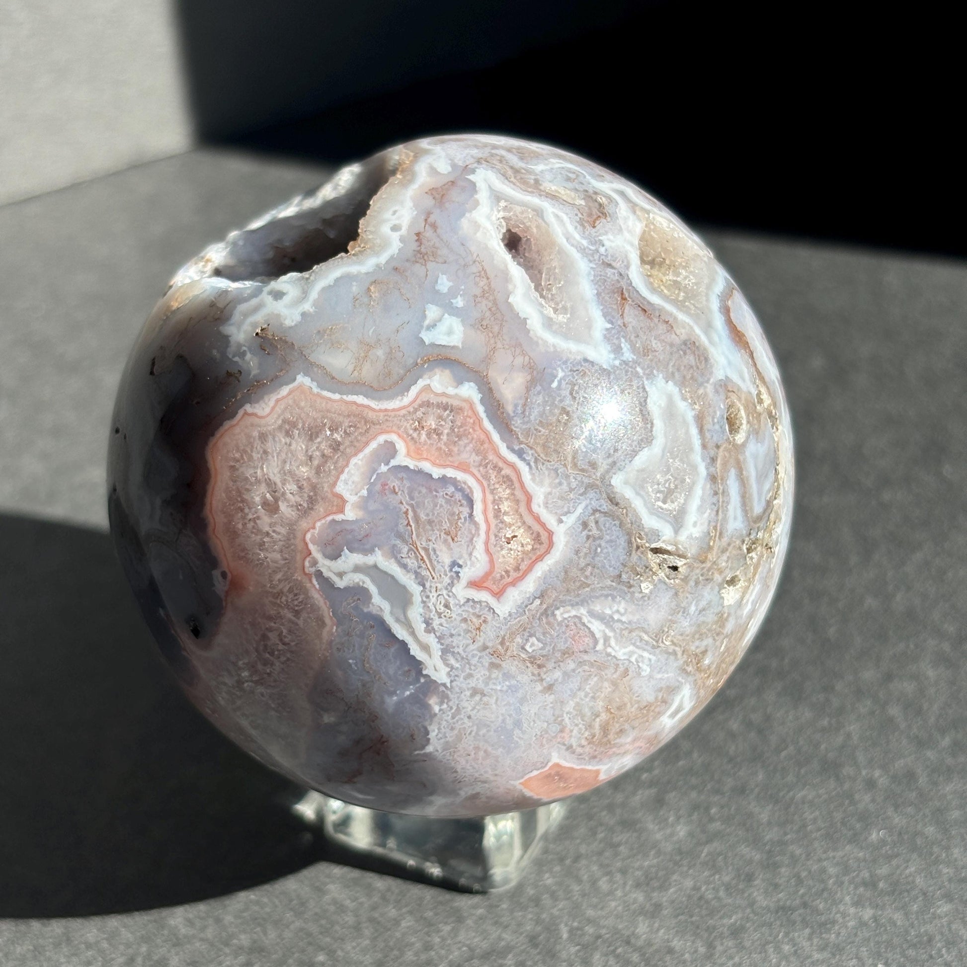 Druzy Pink Moss Agate Crystal Sphere against a black background