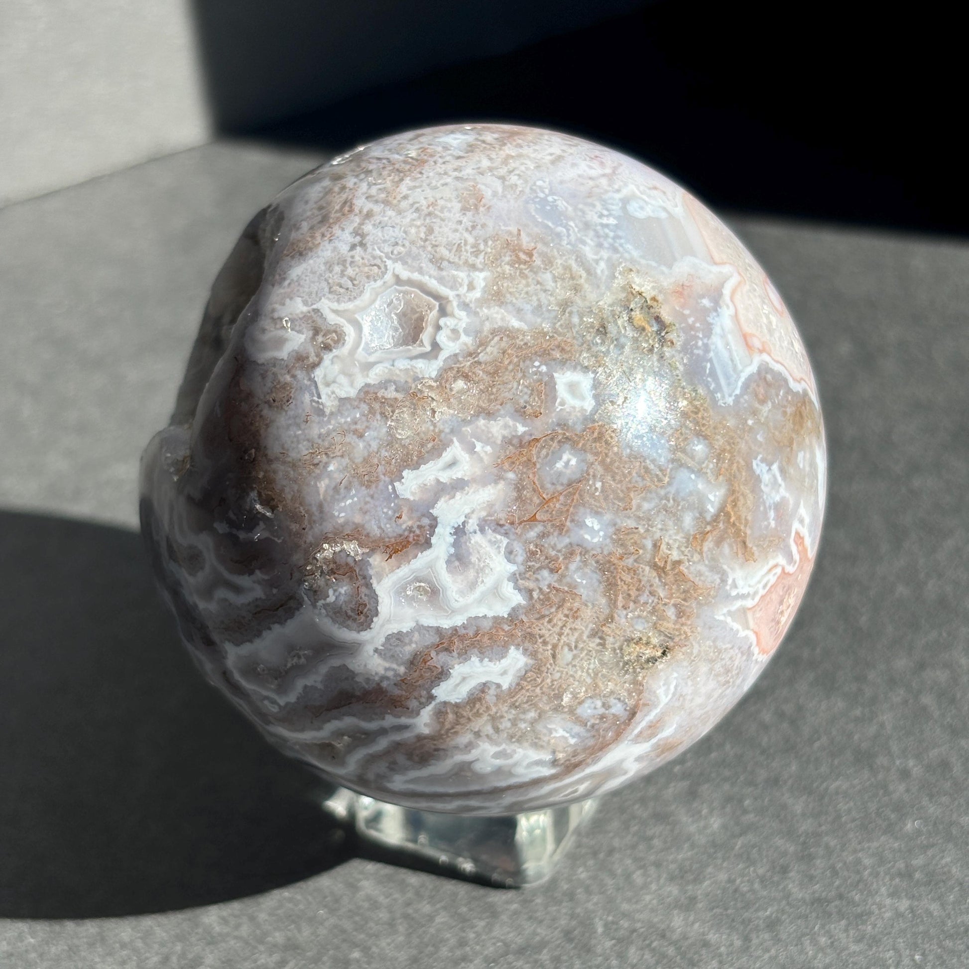 Druzy Pink Moss Agate Crystal Sphere against a black background