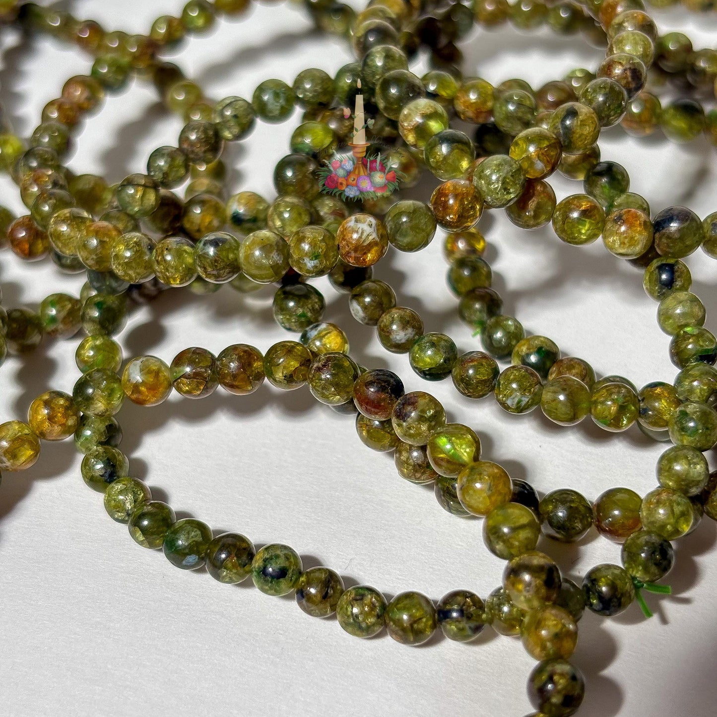 Handmade 4mm genuine peridot beaded stretch bracelet featuring small round vibrant green gemstone beads against a white background. ideal as a minimalist August birthstone jewelry gift.