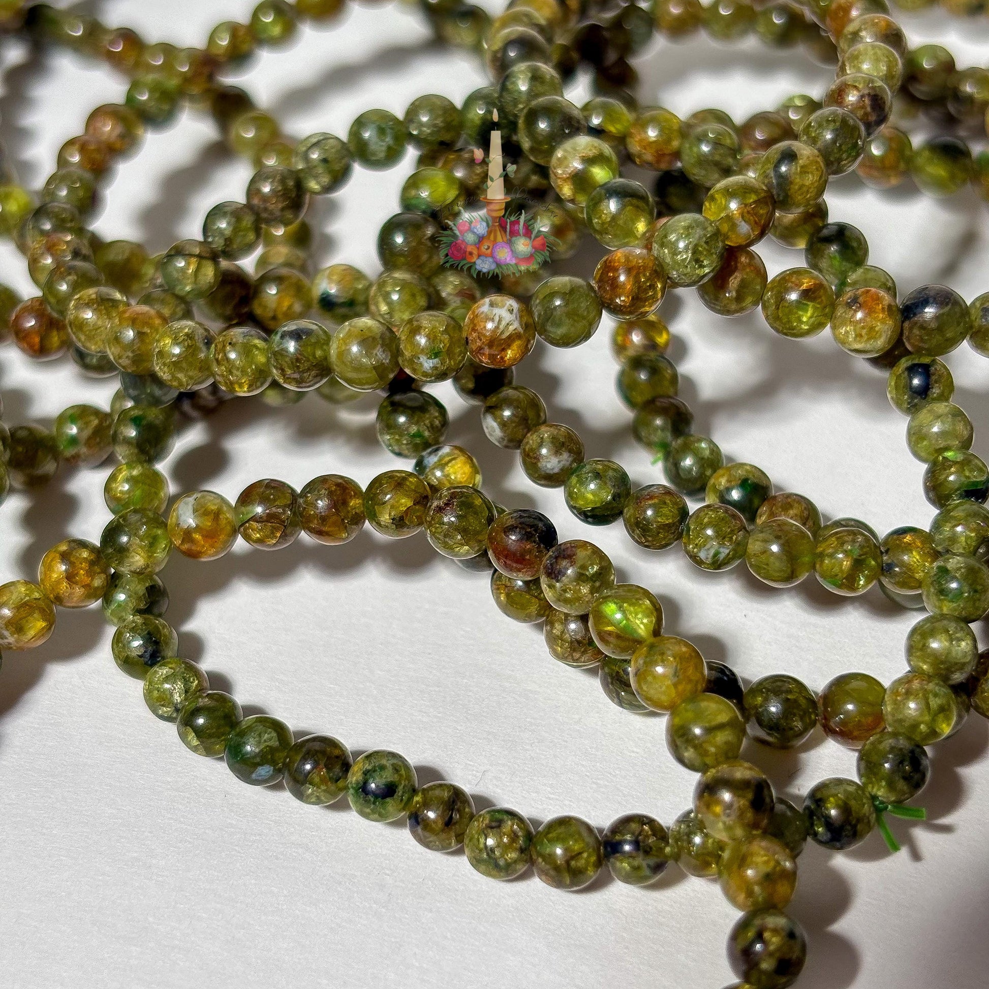 Handmade 4mm genuine peridot beaded stretch bracelet featuring small round vibrant green gemstone beads against a white background. ideal as a minimalist August birthstone jewelry gift.