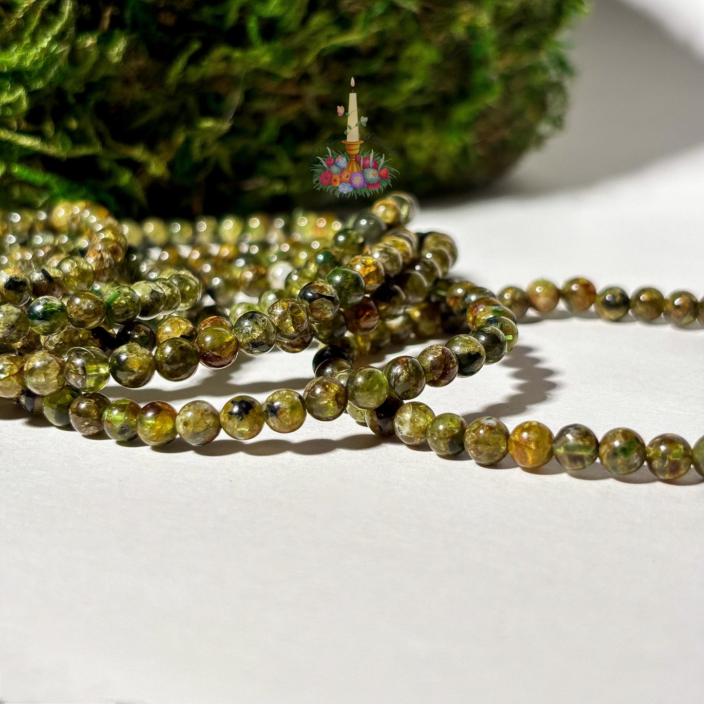 Handmade 4mm genuine peridot beaded stretch bracelet featuring small round vibrant green gemstone beads against a white background. ideal as a minimalist August birthstone jewelry gift.