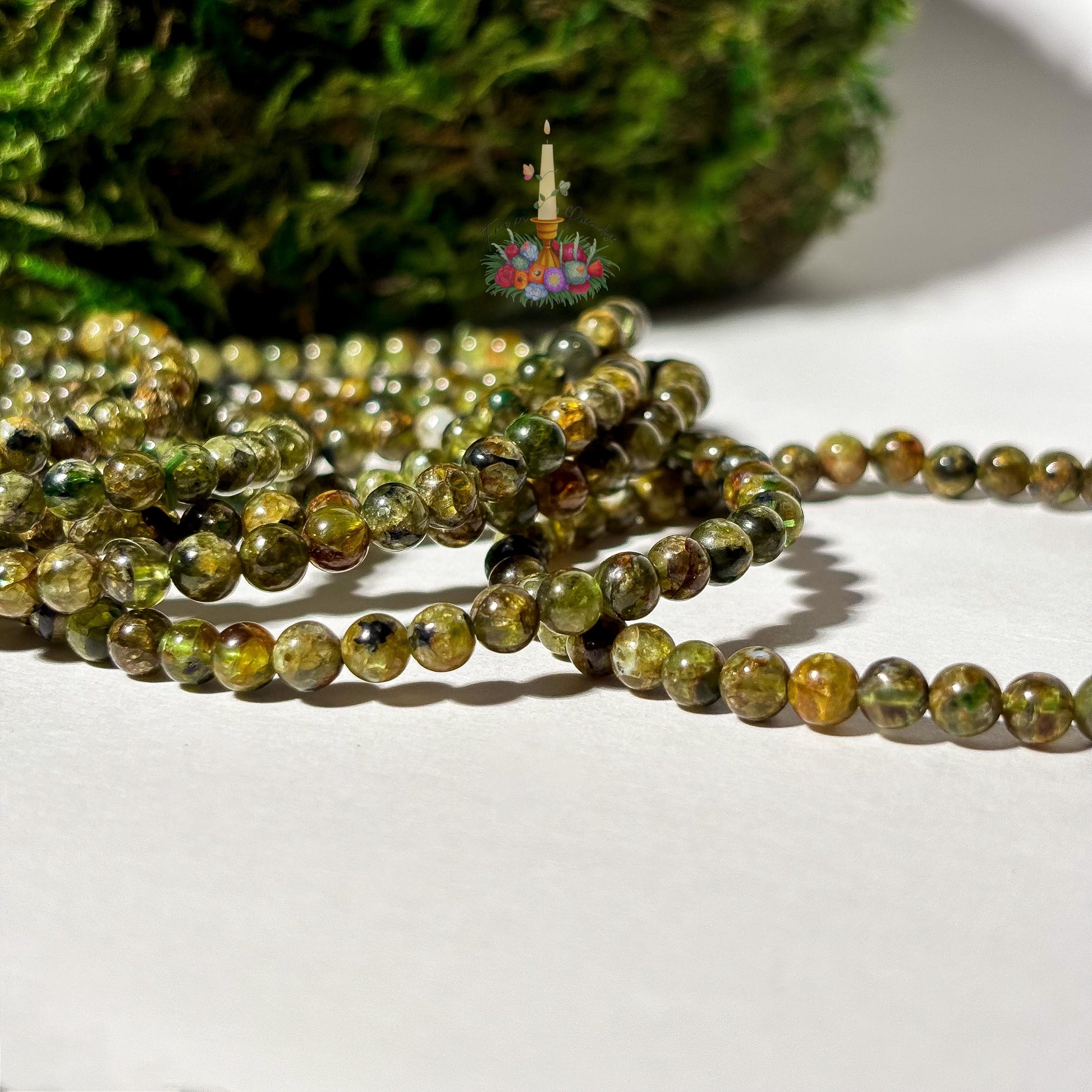 Handmade 4mm genuine peridot beaded stretch bracelet featuring small round vibrant green gemstone beads against a white background. ideal as a minimalist August birthstone jewelry gift.