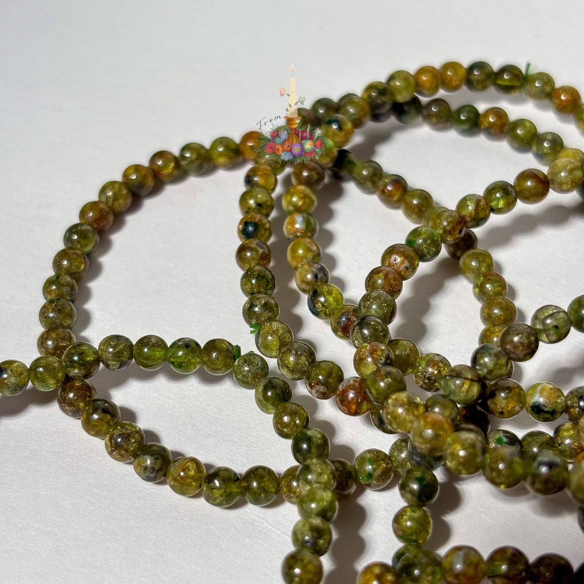 Handmade 4mm genuine peridot beaded stretch bracelet featuring small round vibrant green gemstone beads against a white background. ideal as a minimalist August birthstone jewelry gift.