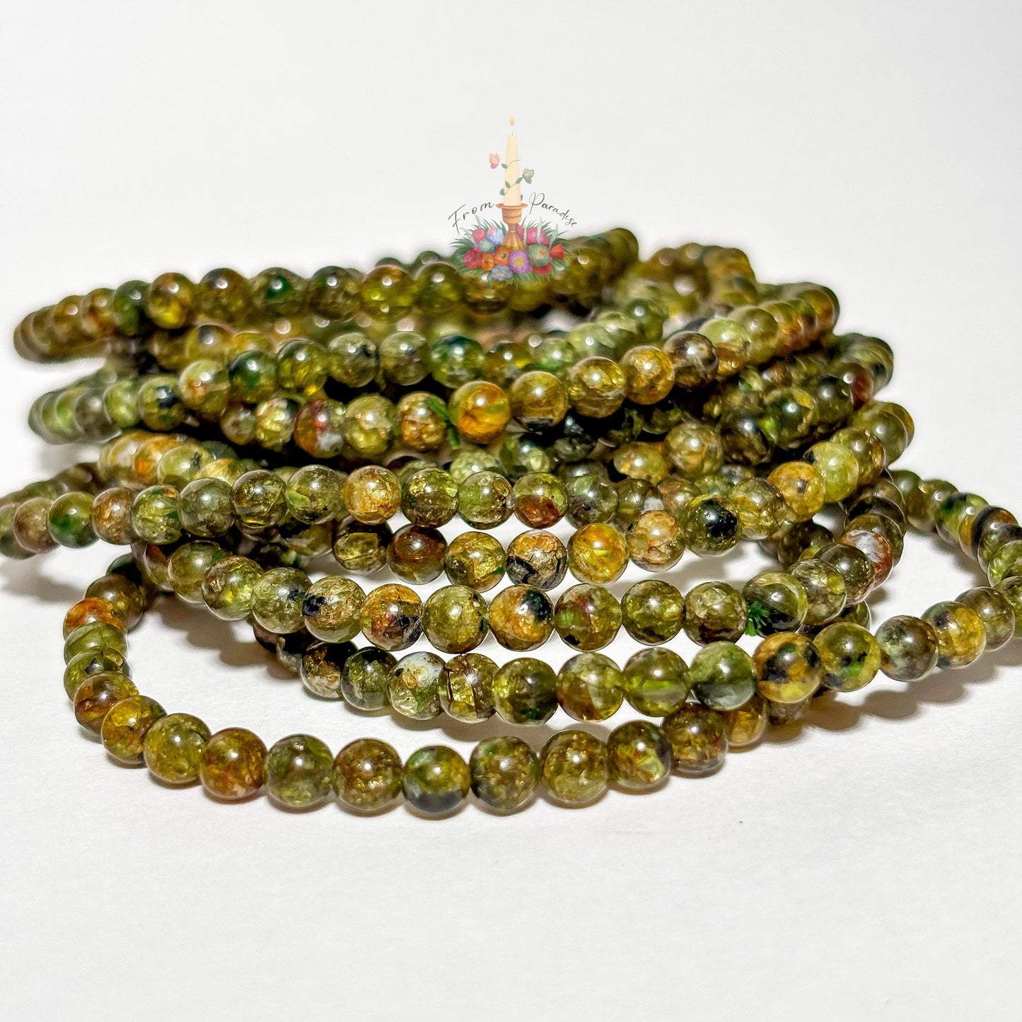 Handmade 4mm genuine peridot beaded stretch bracelet featuring small round vibrant green gemstone beads against a white background. ideal as a minimalist August birthstone jewelry gift.